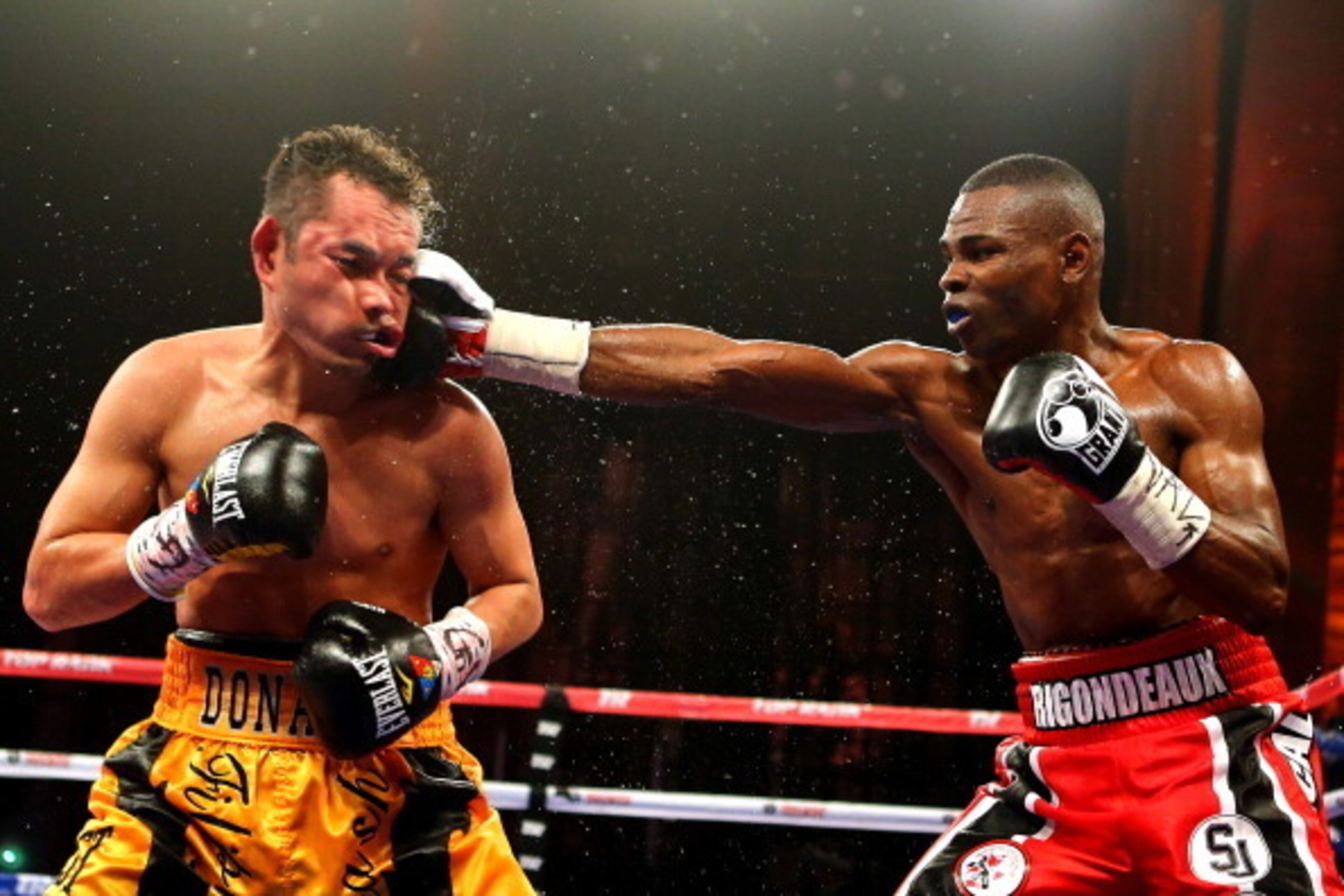 NEW YORK, NY - APRIL 13:  Guillermo Rigondeaux punches Nonito Donaire during their WBO/WBA junior featherweight title unification bout at Radio City Music Hall on April 13, 2013 in New York City.  (Photo by Al Bello/Getty Images)