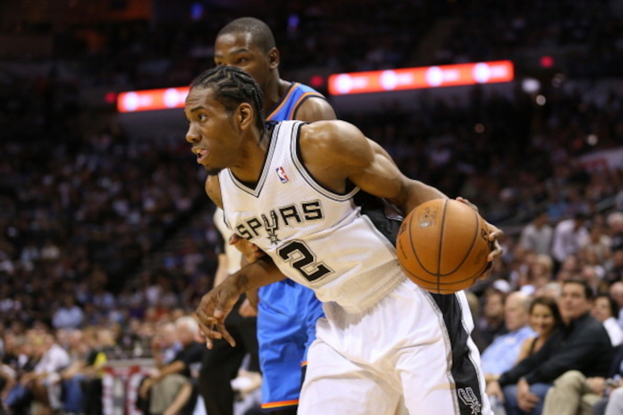 SAN ANTONIO, TX - MAY 21: Kawhi Leonard #2 of the San Antonio Spurs drives on Kevin Durant #35 of the Oklahoma City Thunder in the first quarter in Game Two of the Western Conference Finals during the 2014 NBA Playoffs at AT&T Center on May 21, 2014 in S SAN ANTONIO, TX - MAY 21: Kawhi Leonard #2 of the San Antonio Spurs drives on Kevin Durant #35 of the Oklahoma City Thunder in the first quarter in Game Two of the Western Conference Finals during the 2014 NBA Playoffs at AT&T Center on May 21, 2014 in S