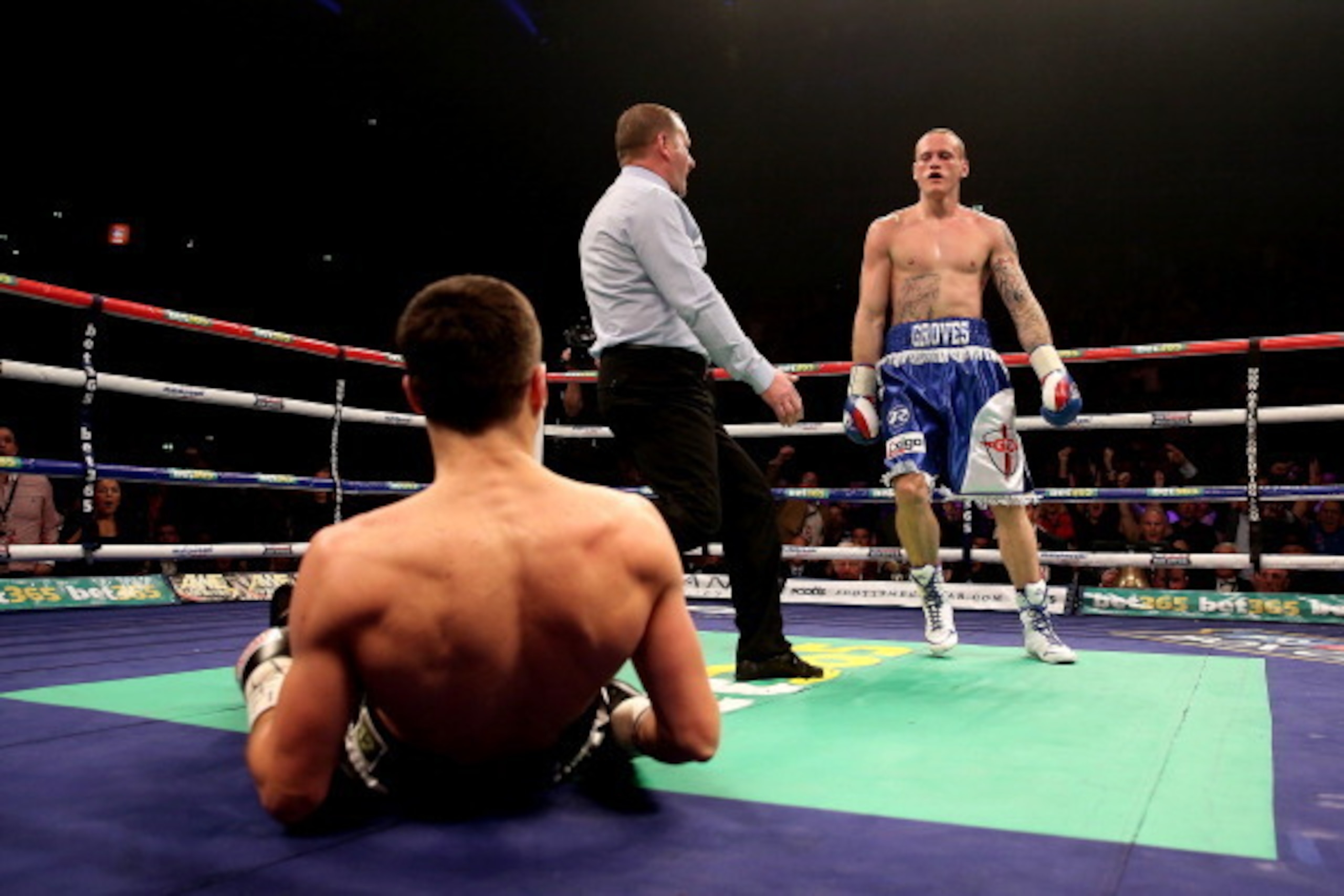 MANCHESTER, ENGLAND - NOVEMBER 23:  Carl Froch is knocked down in the first by George Groves during their IBF and WBA World Super Middleweight bout at Phones4u Arena on November 23, 2013 in Manchester, England.  (Photo by Scott Heavey/Getty Images)