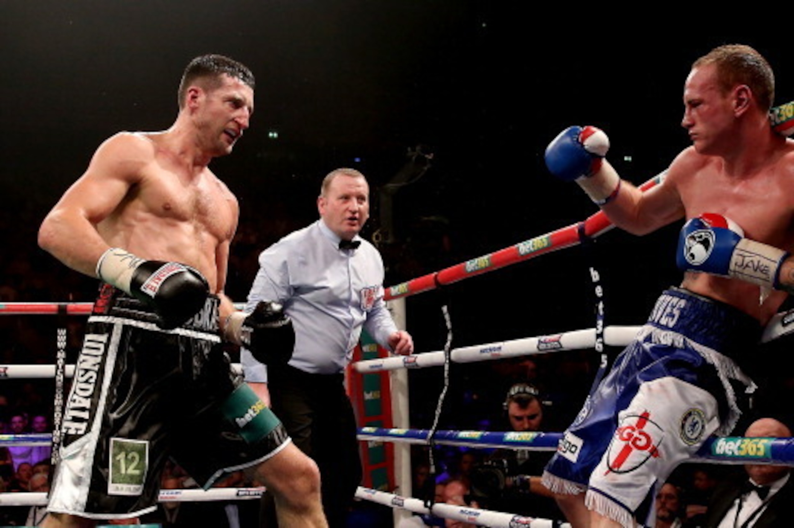 MANCHESTER, ENGLAND - NOVEMBER 23:  Carl Froch bombards George Groves during their IBF and WBA World Super Middleweight bout at Phones4u Arena on November 23, 2013 in Manchester, England.  (Photo by Scott Heavey/Getty Images)