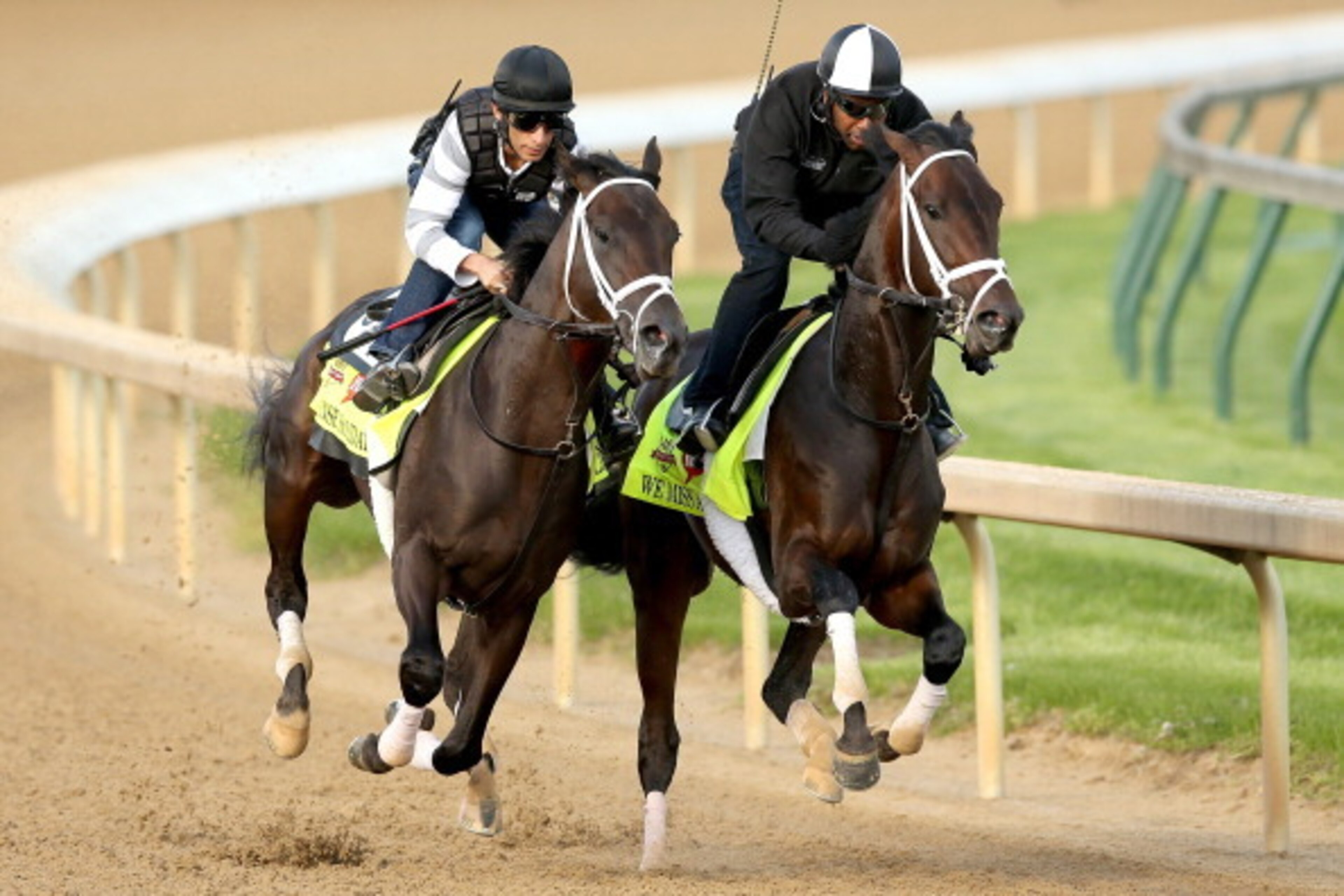 LOUISVILLE, KY - APRIL 27:  Intense Holiday, riden by John Velazquez, and We Miss Artie, riden Nick Bush, work out together during the morning exercise session in preparation for the140th Kentucky Derby at Churchill Downs on April 27, 2014 in Louisville, 
