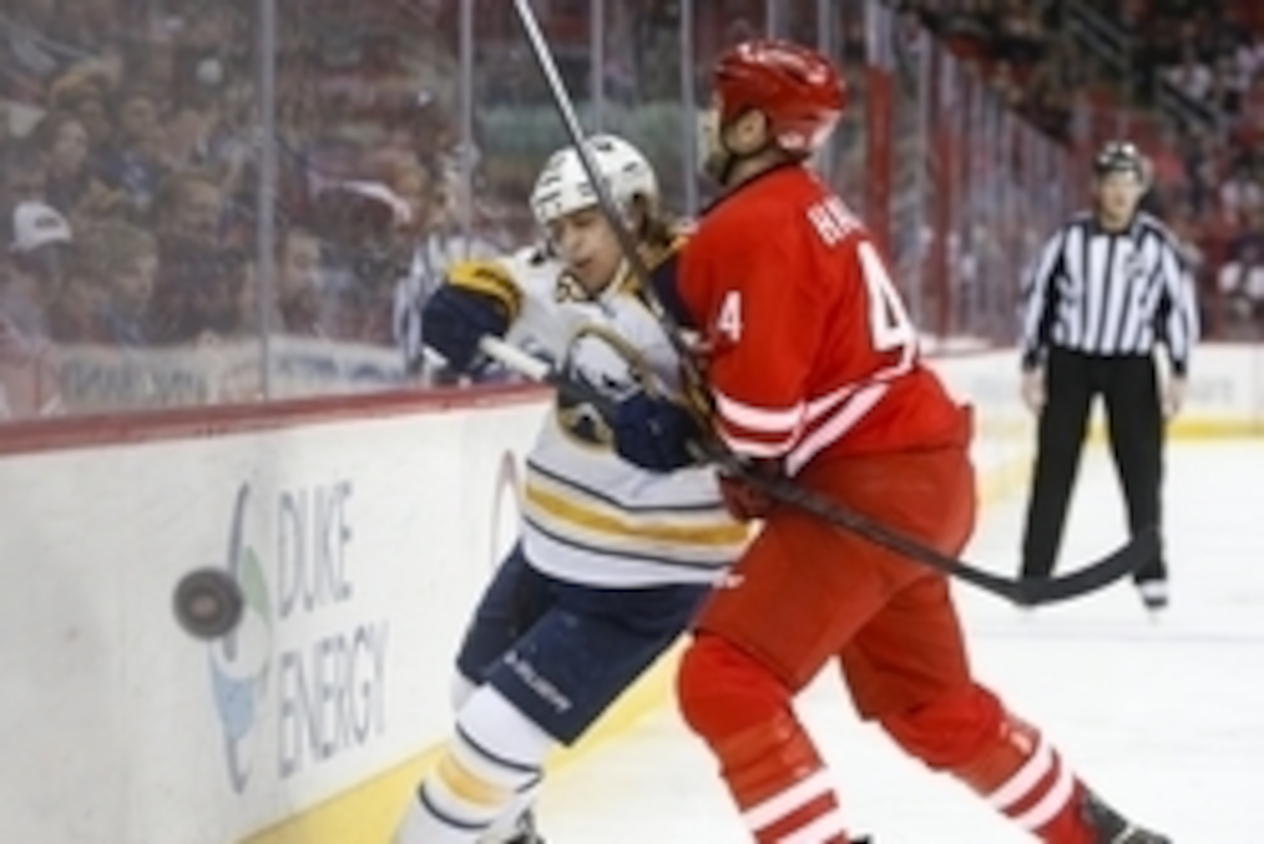 Mar 13, 2014; Raleigh, NC, USA; Carolina Hurricanes defensemen Jay Harrison (44) checks Buffalo Sabres forward Tyler Ennis (63) during the third period at PNC Arena. The Carolina Hurricanes defeated the Buffalo Sabres 4-2. Mandatory Credit: James Guillory