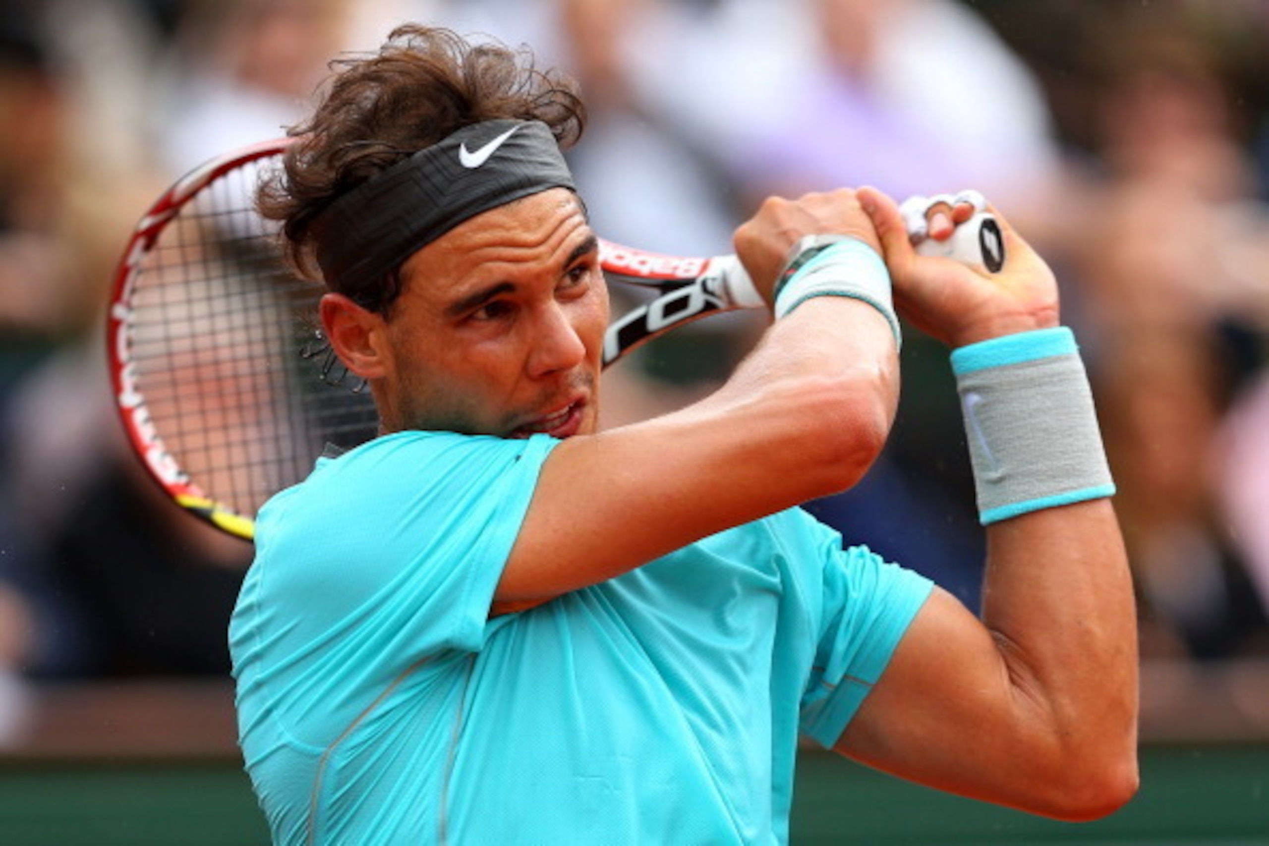 PARIS, FRANCE - MAY 29:  Rafael Nadal of Spain returns a shot during his men's singles match against dominic thiem of Austria on day five of the French Open at Roland Garros on May 29, 2014 in Paris, France.  (Photo by Clive Brunskill/Getty Images)