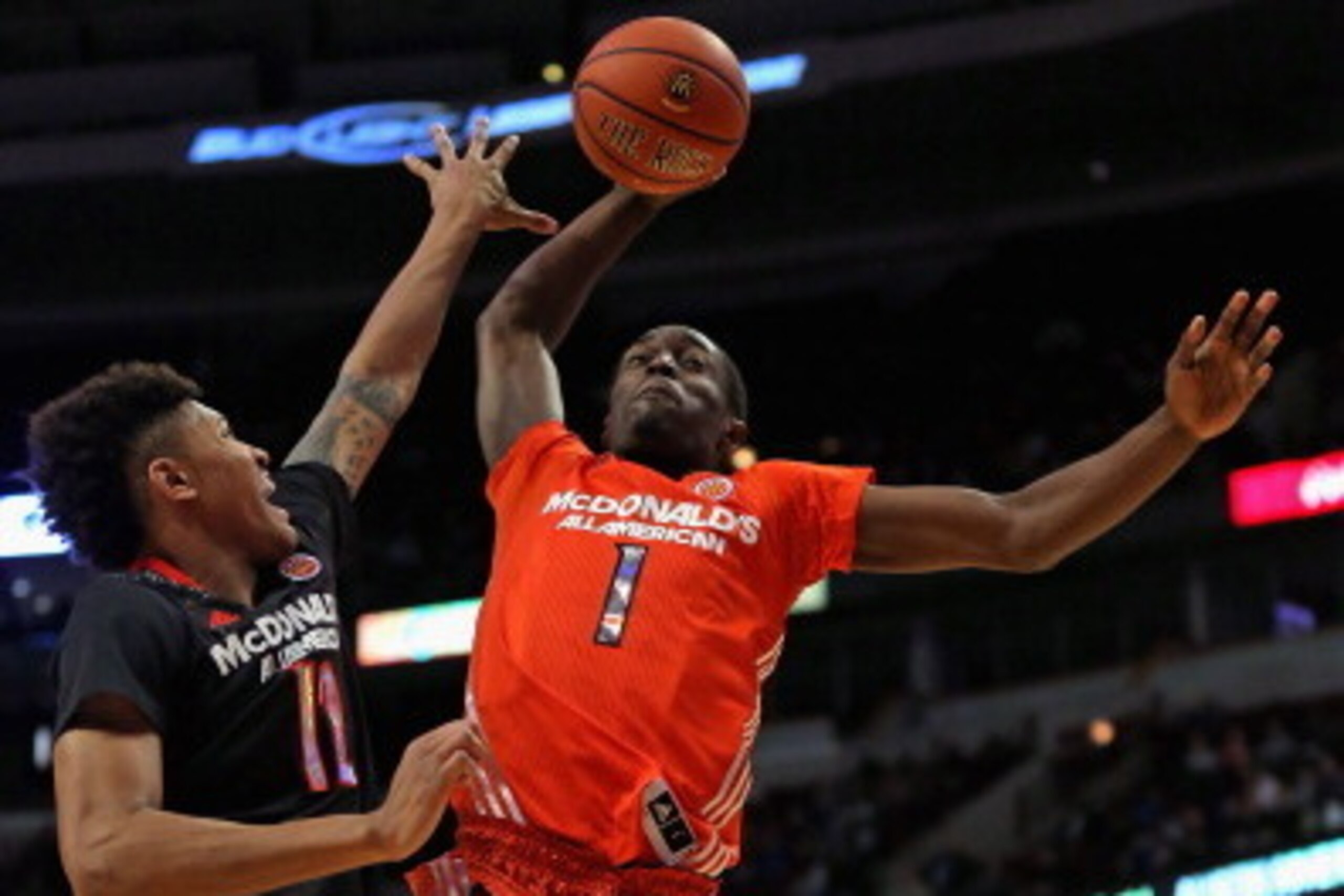 CHICAGO, IL - APRIL 2: Theo Pinson #1 of the East team goes up for a dunk against Kelly Oubre Jr. #12 of the West team during the 2014 McDonald's All American Game at United Center on April 2, 2014 in Chicago, Illinois. The West defeated the East 105-102.