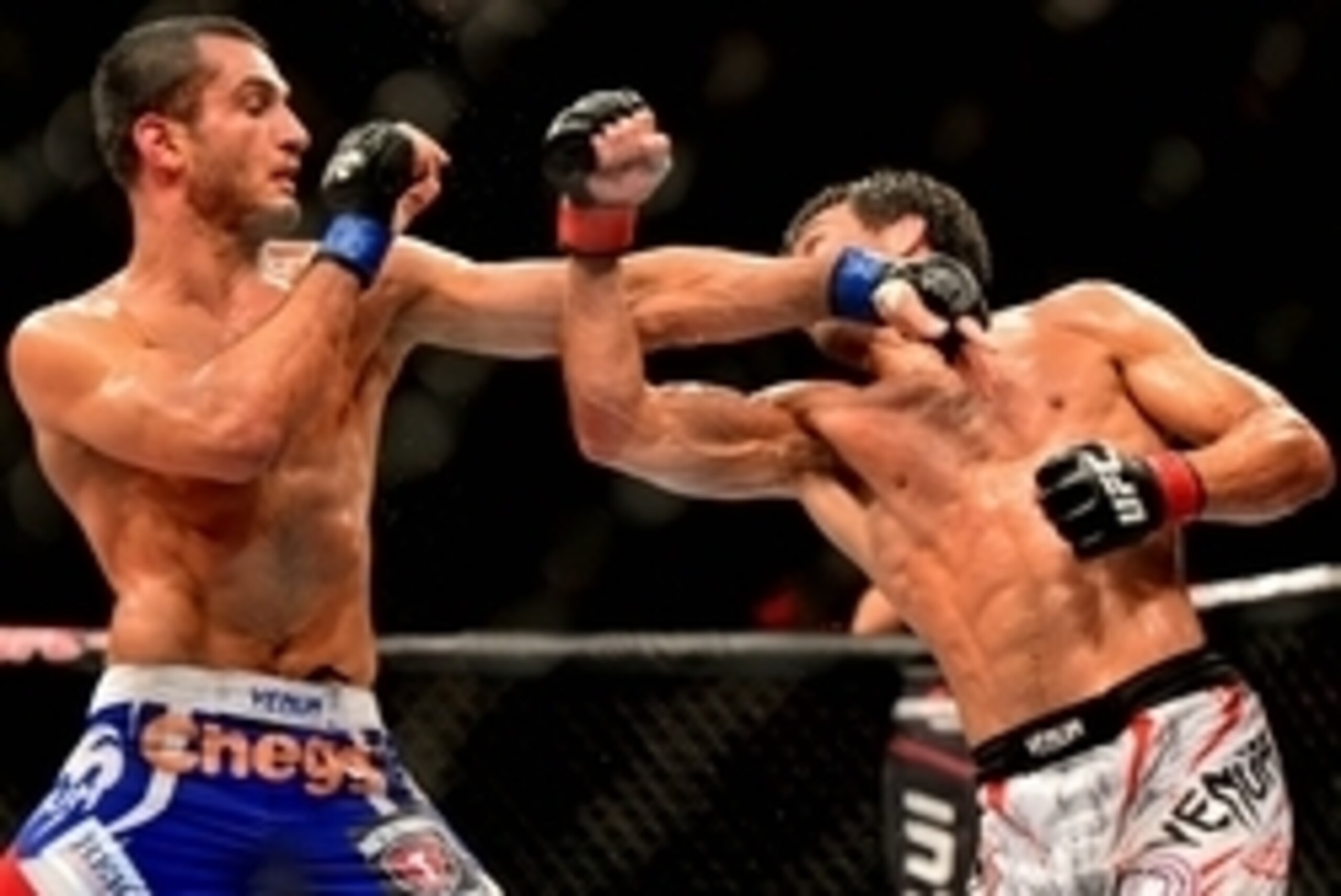 Feb 15, 2014; Jaragua do Sul, SC, Brazil; Lyoto Machida (red gloves) fights against Gegard Mousasi (blue gloves) during UFC Fight Night Machida vs Mousasi at Arena Jaragua. Mandatory Credit: Jason Silva-USA TODAY Sports