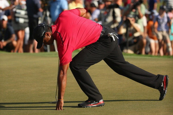 DORAL, FL - MARCH 09:  Tiger Woods collects his golf ball during the final round of the World Golf Championships-Cadillac Championship at Trump National Doral on March 9, 2014 in Doral, Florida.  (Photo by Mike Ehrmann/Getty Images)