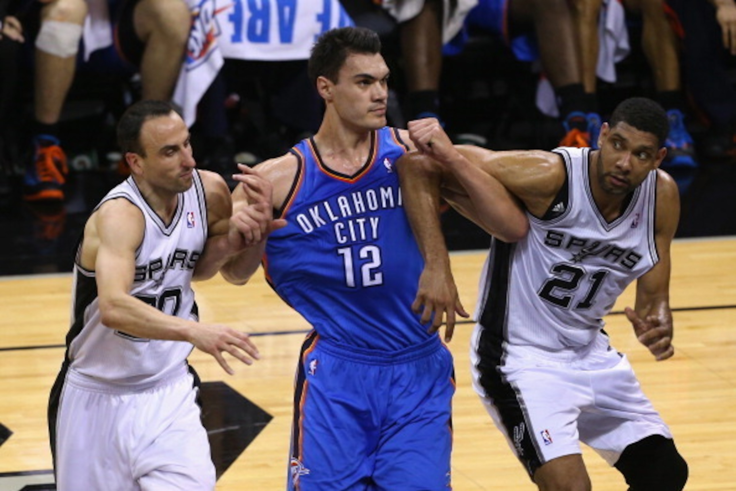 SAN ANTONIO, TX - MAY 29: Steven Adams #12 of the Oklahoma City Thunder fights for position with Manu Ginobili #20 and Tim Duncan #21 of the San Antonio Spurs in the first half during Game Five of the Western Conference Finals of the 2014 NBA Playoffs at SAN ANTONIO, TX - MAY 29: Steven Adams #12 of the Oklahoma City Thunder fights for position with Manu Ginobili #20 and Tim Duncan #21 of the San Antonio Spurs in the first half during Game Five of the Western Conference Finals of the 2014 NBA Playoffs at