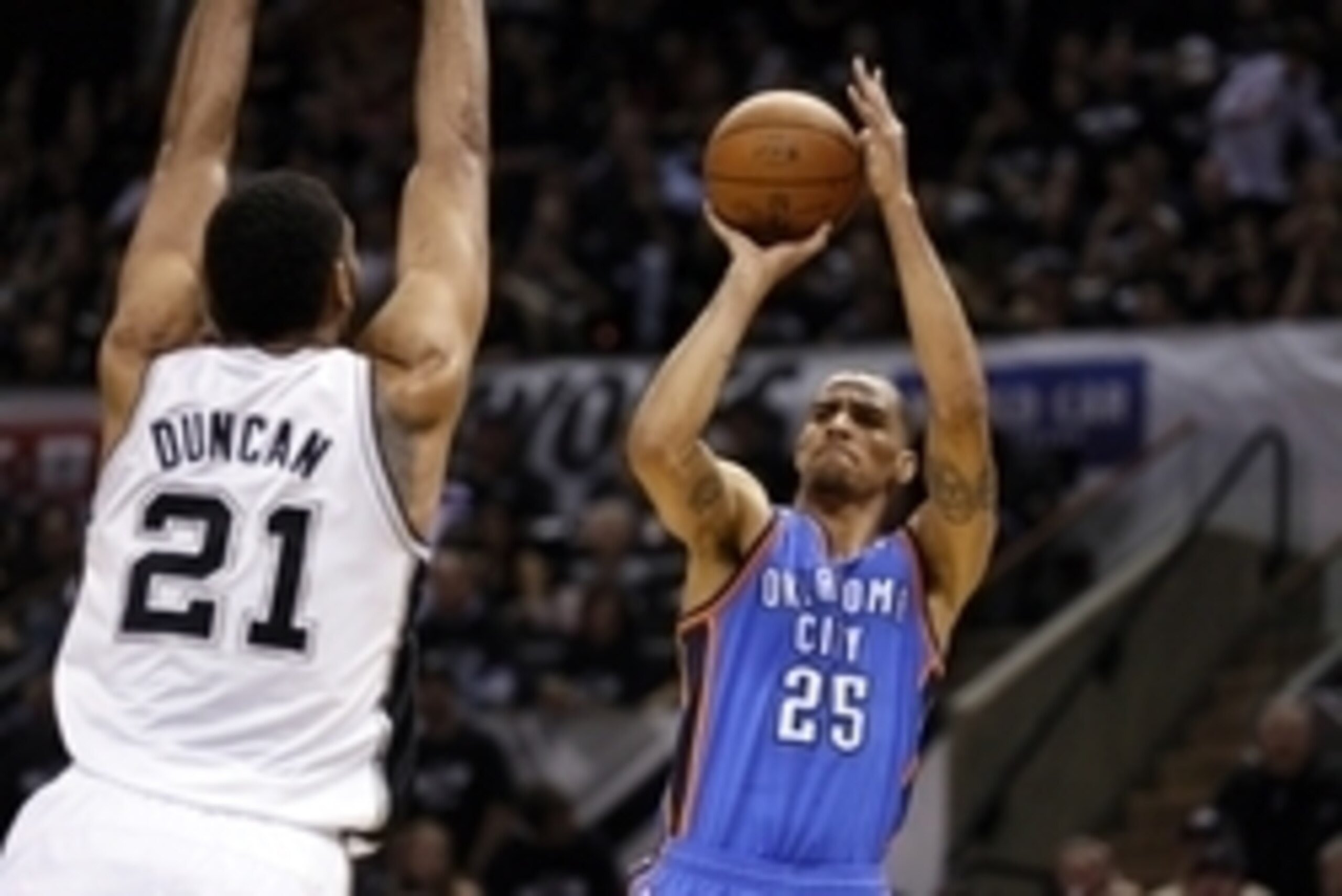 May 19, 2014; San Antonio, TX, USA; Oklahoma City Thunder guard Thabo Sefolosha (25) shoots the ball over San Antonio Spurs forward Tim Duncan (21) in game one of the Western Conference Finals in the 2014 NBA Playoffs at AT&T Center. Mandatory Credit: Soo