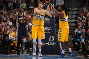 DENVER, CO - April 12: Timofey Mozgov #25 and Kenneth Faried #35 of the Denver Nuggets celebrate during a game against the Utah Jazz on April 12, 2014 at the Pepsi Center in Denver, Colorado. NOTE TO USER: User expressly acknowledges and agrees that, by d