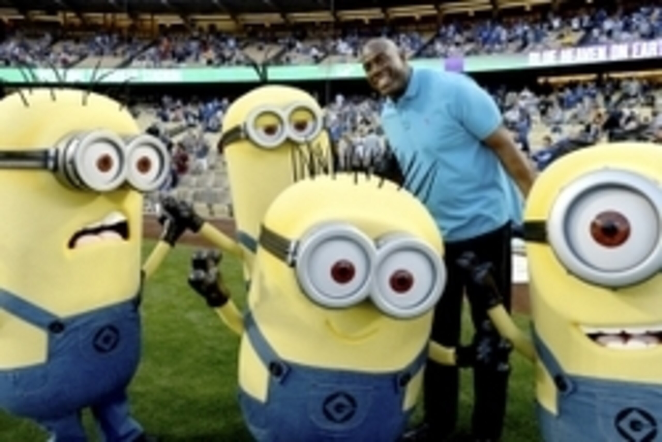 Apr 9, 2014; Los Angeles, CA, USA;  Los Angeles Dodgers owner Magic Johnson with Minion characters from the movie Despicable Me before the game against the Detroit Tigers at Dodger Stadium. Mandatory Credit: Jayne Kamin-Oncea-USA TODAY Sports
