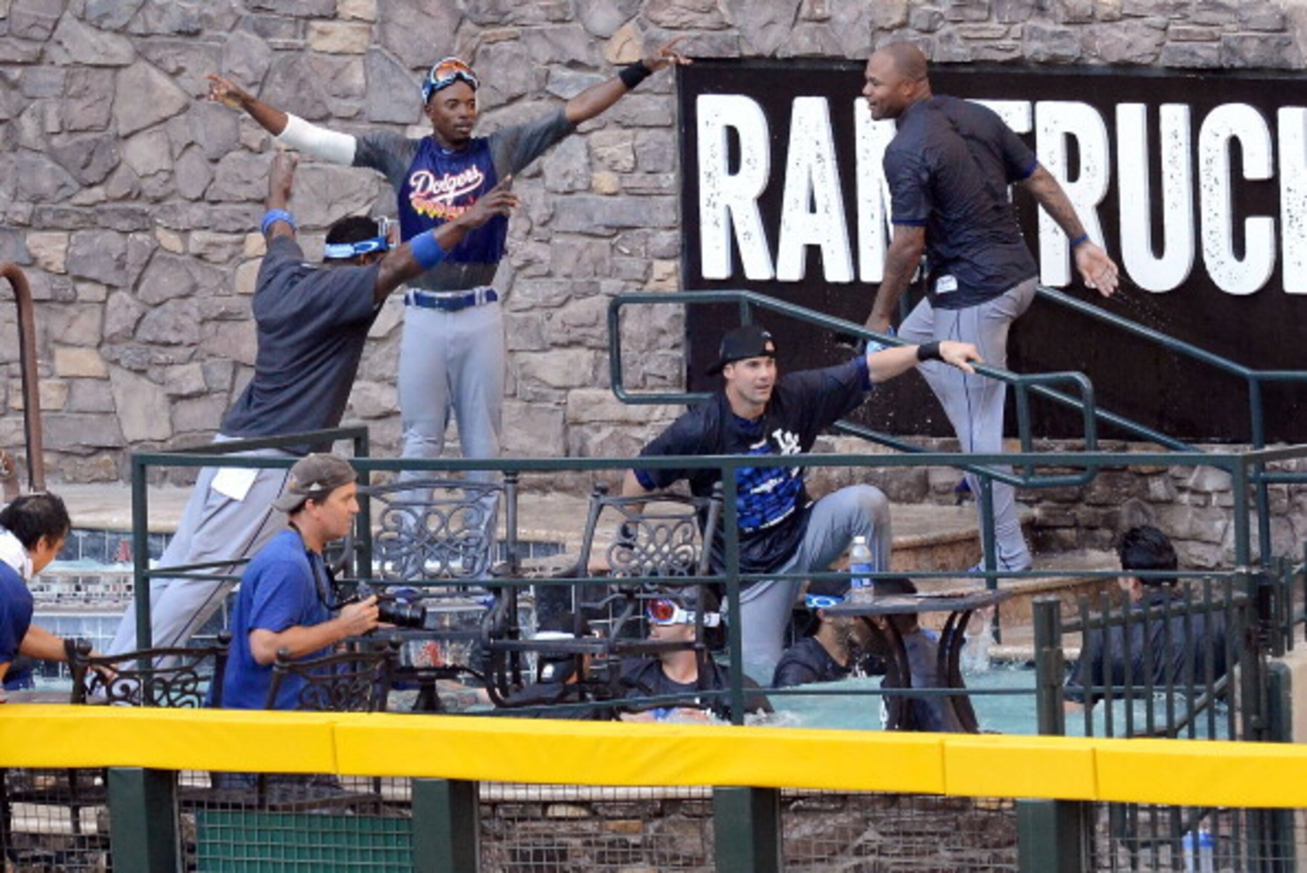 PHOENIX, AZ - SEPTEMBER 19:  Los Angeles Dodgers players jump in the pool after clinching the National League West after a 7-6 win against the Arizona Diamondbacks at Chase Field on September 19, 2013 in Phoenix, Arizona.  (Photo by Norm Hall/Getty Images