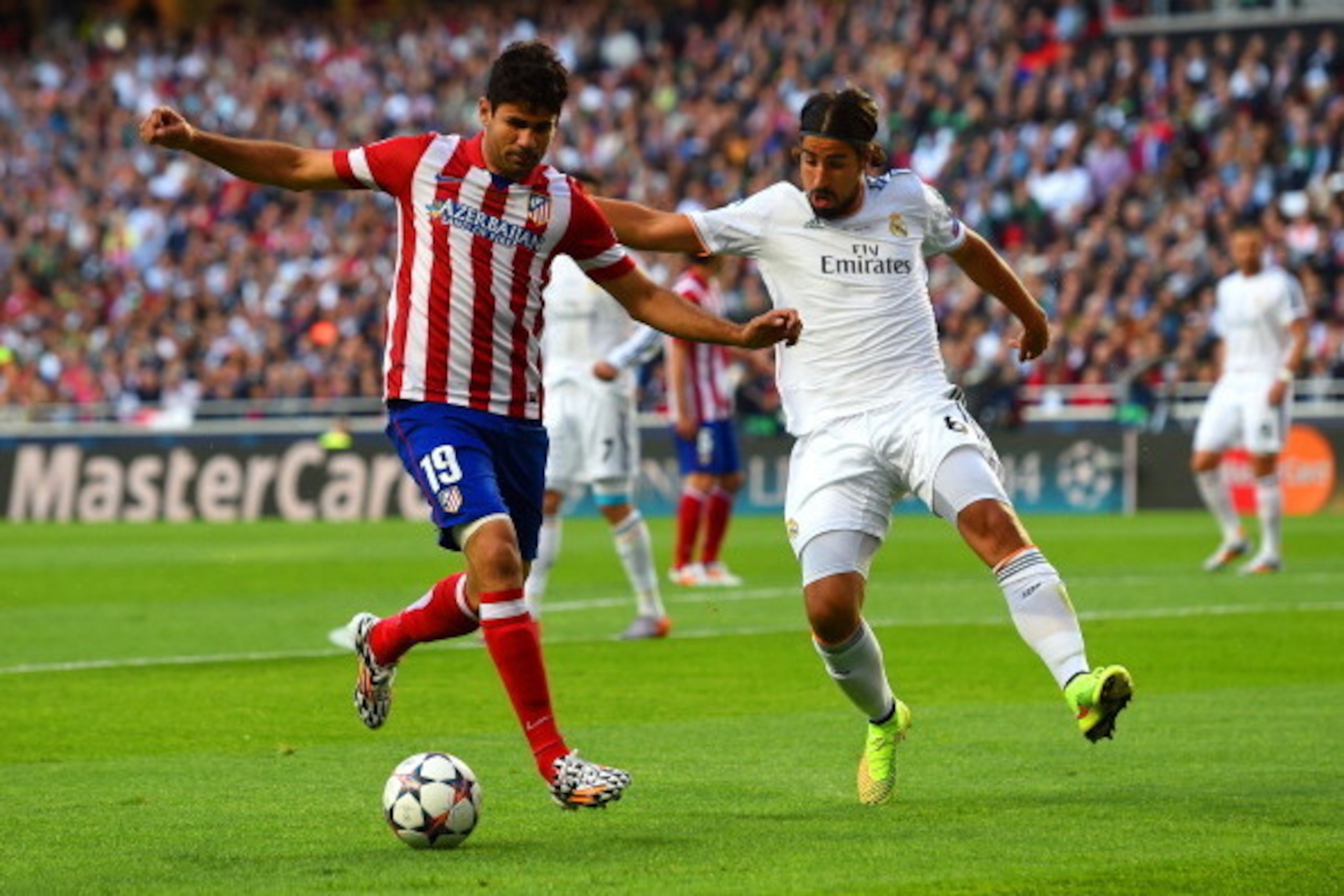 LISBON, PORTUGAL - MAY 24:  Diego Costa of Club Atletico de Madrid is marshalled by Sami Khedira of Real Madrid during the UEFA Champions League Final between Real Madrid and Atletico de Madrid at Estadio da Luz on May 24, 2014 in Lisbon, Portugal.  (Phot