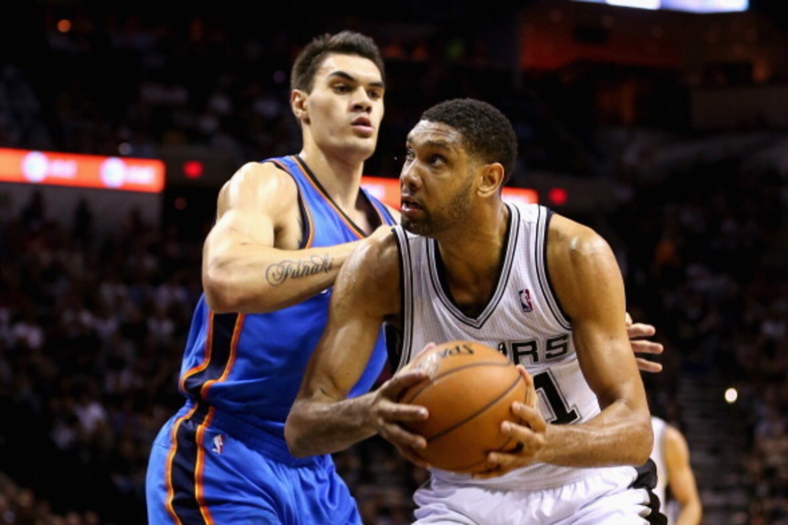SAN ANTONIO, TX - MAY 29: Tim Duncan #21 of the San Antonio Spurs drives to the basket against Steven Adams #12 of the Oklahoma City Thunder in the second quarter during Game Five of the Western Conference Finals of the 2014 NBA Playoffs at AT&T Center on