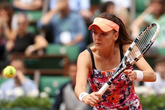 PARIS, FRANCE - MAY 30:  Agnieszka Radwanska of Poland returns a shot during her women's singles match against Ajla Tomljanovic of Croatia on day six of the French Open at Roland Garros on May 30, 2014 in Paris, France.  (Photo by Matthew Stockman/Getty I