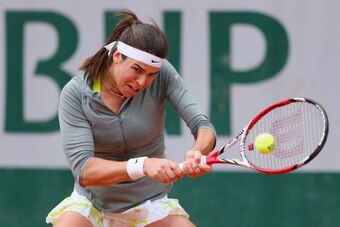 PARIS, FRANCE - MAY 28:  Ajla Tomljanovic of Croatia returns a shot during her women's singles match against Elena Vesnina of Russia on day four of the French Open at Roland Garros on May 28, 2014 in Paris, France.  (Photo by Clive Brunskill/Getty Images)