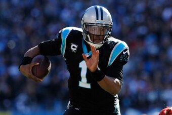 CHARLOTTE, NC - JANUARY 12: Cam Newton #1 of the Carolina Panthers runs with the ball in the second quarter against the San Francisco 49ers during the NFC Divisional Playoff Game at Bank of America Stadium on January 12, 2014 in Charlotte, North Carolina.