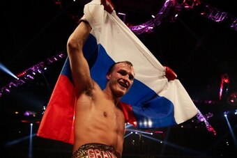 MACAU - NOVEMBER 24:  Evgeny Gradovich of Russia celebrates defeating Billy Dib of Australia during their 'Clash in Cotai' IBF Featherweight title bout on November 24, 2013 in Macau.  (Photo by Nicky Loh/Getty Images)