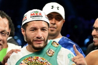 CARSON, CA - AUGUST 24:  Jhonny Gonzalez poses with the belt as he beats Abner Mares in a first round konckout during the WBC Featherweight Title Fight at the StubHub Center on August 24, 2013 in Carson, California.  (Photo by Harry How/Getty Images)