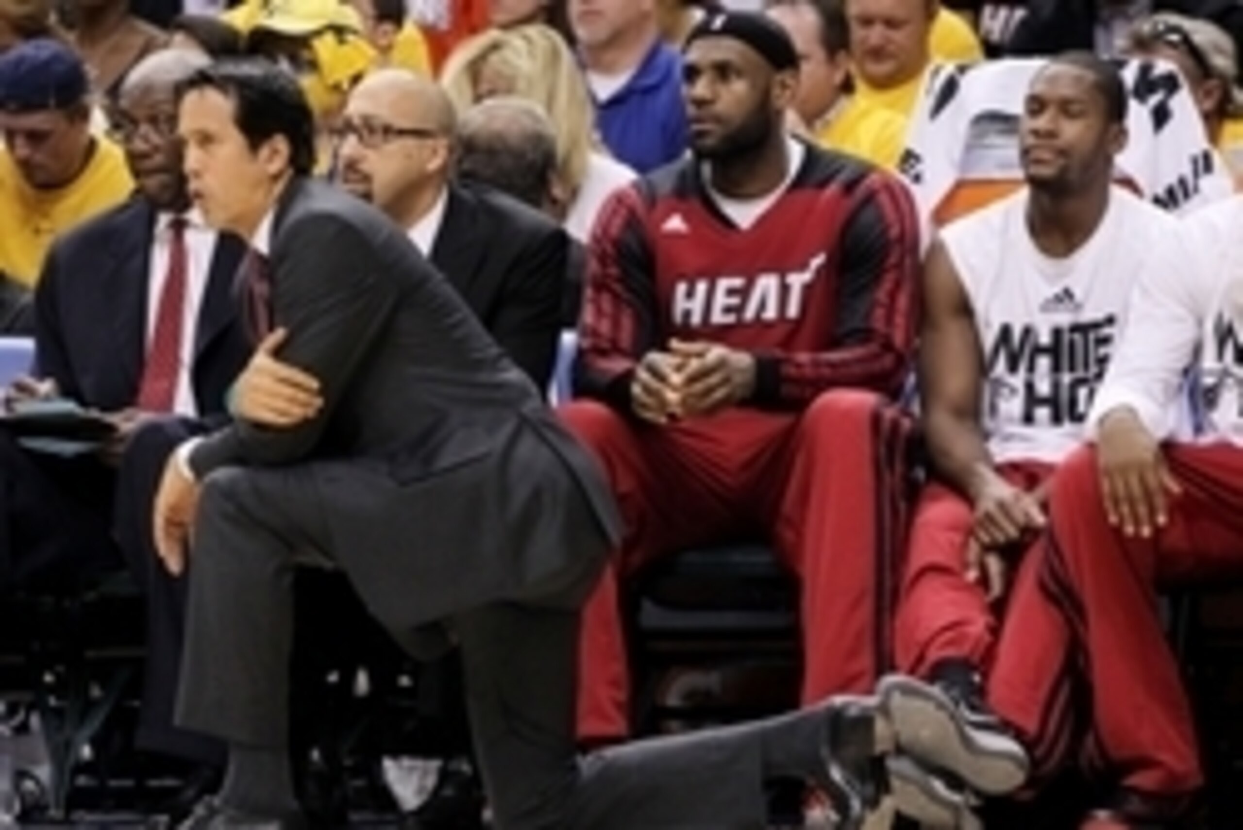 May 28, 2014; Indianapolis, IN, USA; Miami Heat head coach Erik Spoelstra kneels courtside with  forward LeBron James (6) sitting on the bench during the second half in game five against the Indiana Pacers of the Eastern Conference Finals of the 2014 NBA