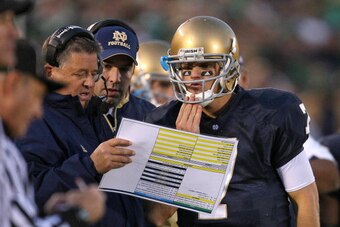 SOUTH BEND, IN - OCTOBER 17: Head coach Charlie Weis of the Notre Dame Fighting Irish gives a play to quarterback Jimmy Clausen #7 during a game against the USC Trojans at Notre Dame Stadium on October 17, 2009 in South Bend, Indiana. USC defeated Notre D