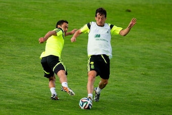 LAS ROZAS DE MADRID, SPAIN - MAY 28:  David Silva of Spain duels for the ball with Xavi Hernandez of Spain during a training session at Ciudad del Futbol on May 28, 2014 in Las Rozas de Madrid, Spain.  (Photo by David Ramos/Getty Images)