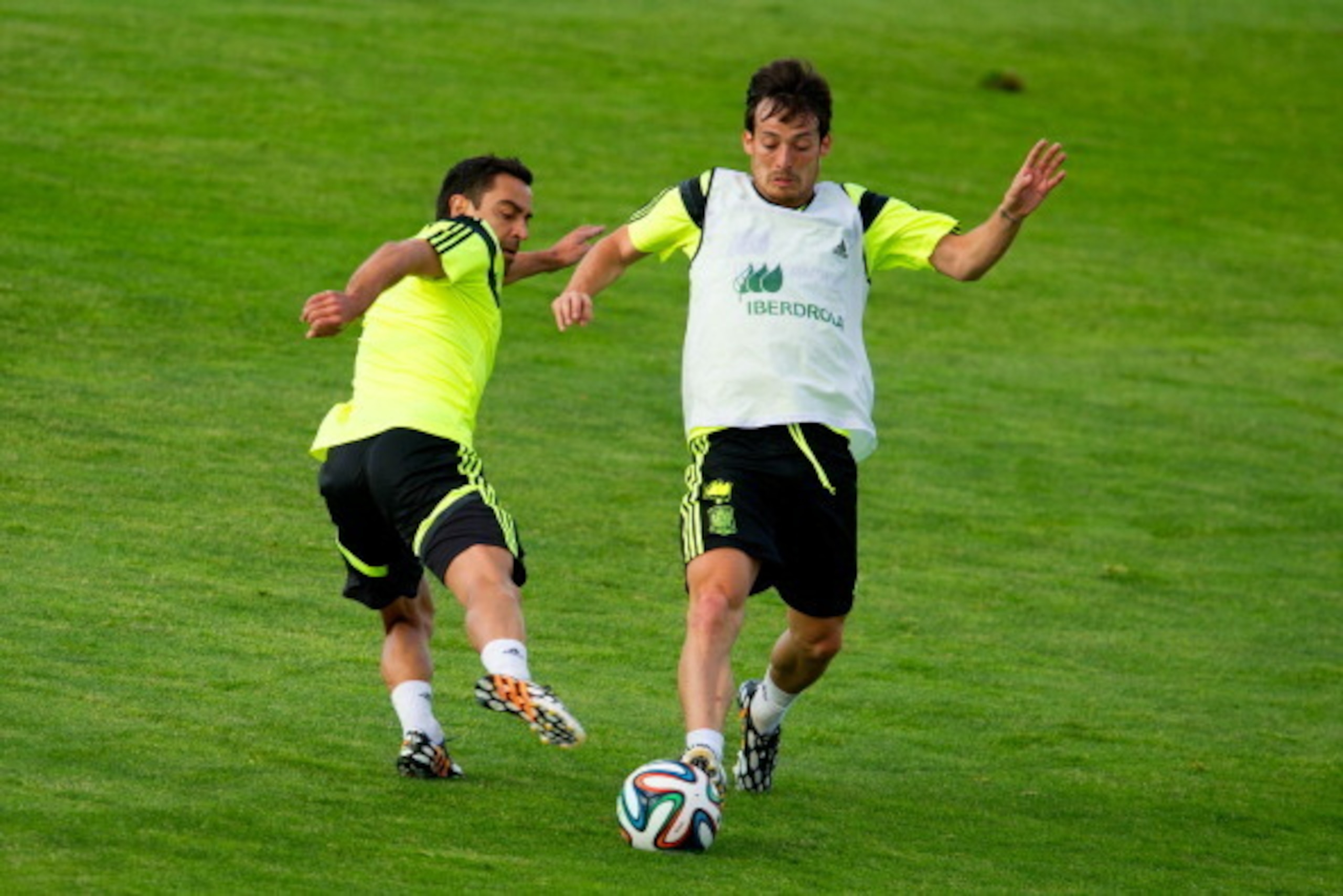 LAS ROZAS DE MADRID, SPAIN - MAY 28:  David Silva of Spain duels for the ball with Xavi Hernandez of Spain during a training session at Ciudad del Futbol on May 28, 2014 in Las Rozas de Madrid, Spain.  (Photo by David Ramos/Getty Images)