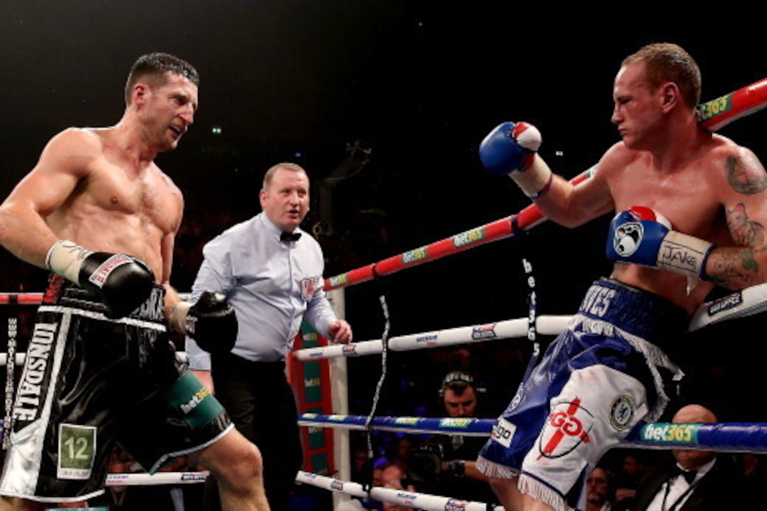 MANCHESTER, ENGLAND - NOVEMBER 23:  Carl Froch bombards George Groves during their IBF and WBA World Super Middleweight bout at Phones4u Arena on November 23, 2013 in Manchester, England.  (Photo by Scott Heavey/Getty Images)