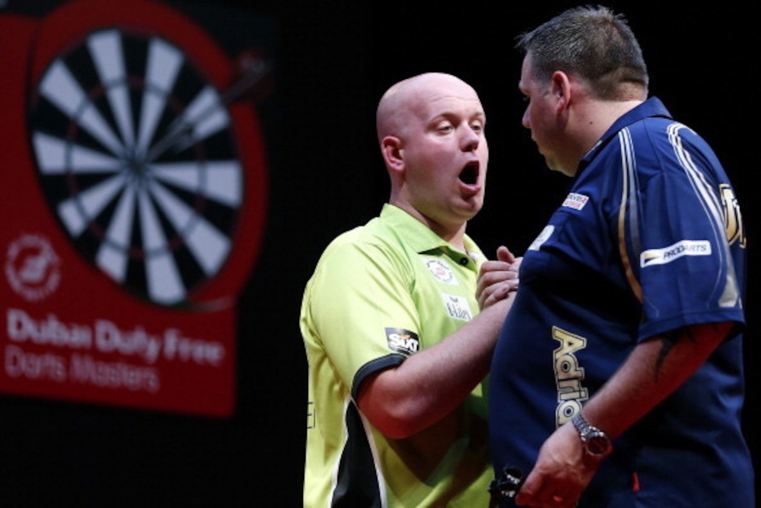 DUBAI, UNITED ARAB EMIRATES - MAY 30: Michael Van Grewen (L) of the Netherlands is congraulated by Adrian Lewis (R) of England after winning the 2014 Dubai Duty Free Darts Masters Semi-Final match at Dubai Duty Free Tennis Stadium, Irish Village on May 3 DUBAI, UNITED ARAB EMIRATES - MAY 30: Michael Van Grewen (L) of the Netherlands is congraulated by Adrian Lewis (R) of England after winning the 2014 Dubai Duty Free Darts Masters Semi-Final match at Dubai Duty Free Tennis Stadium, Irish Village on May 3