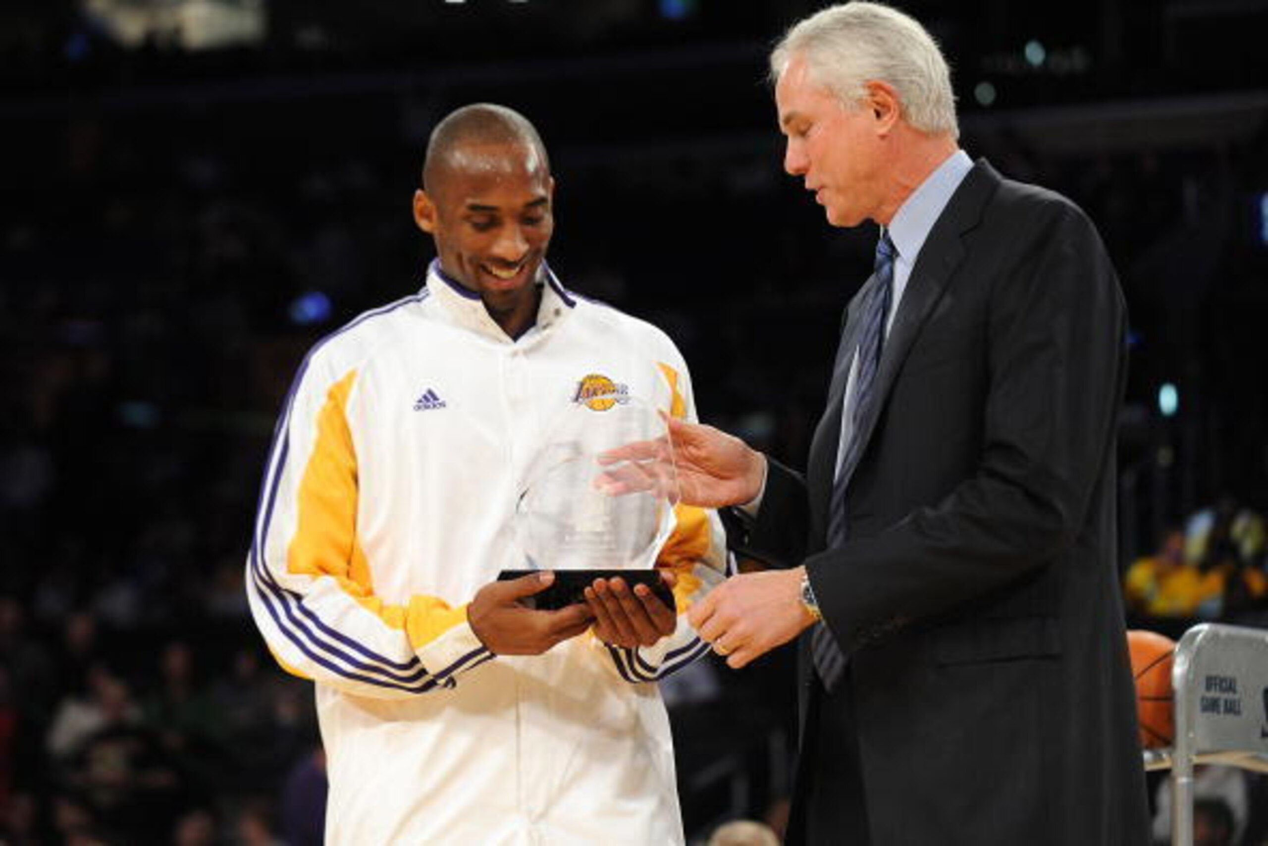 LOS ANGELES - MARCH 3:  General manager Mitch Kupchak of the Los Angeles Lakers presents Kobe Bryant #24 with the Kia Motors Western Conference Player of the Month award for the month of January 2009 before a game against the Memphis Grizzlies at Staples 