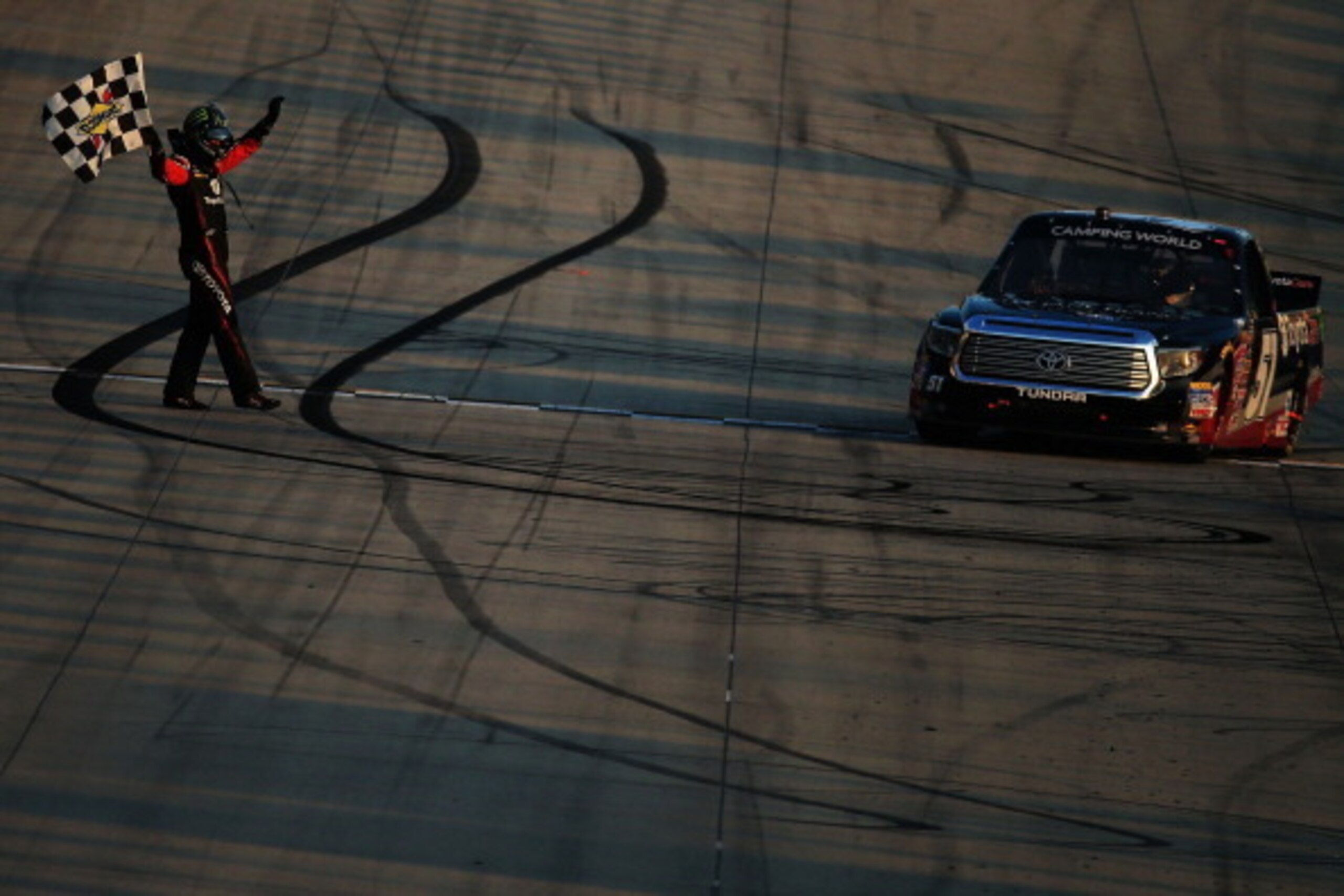 DOVER, DE - MAY 30:  Kyle Busch, driver of the #51 Betty Jane France Humanitarian Award Toyota, celebrates with the checkered flag after winning the NASCAR Camping World Truck Series Lucas Oil 200 at Dover International Speedway on May 30, 2014 in Dover, 