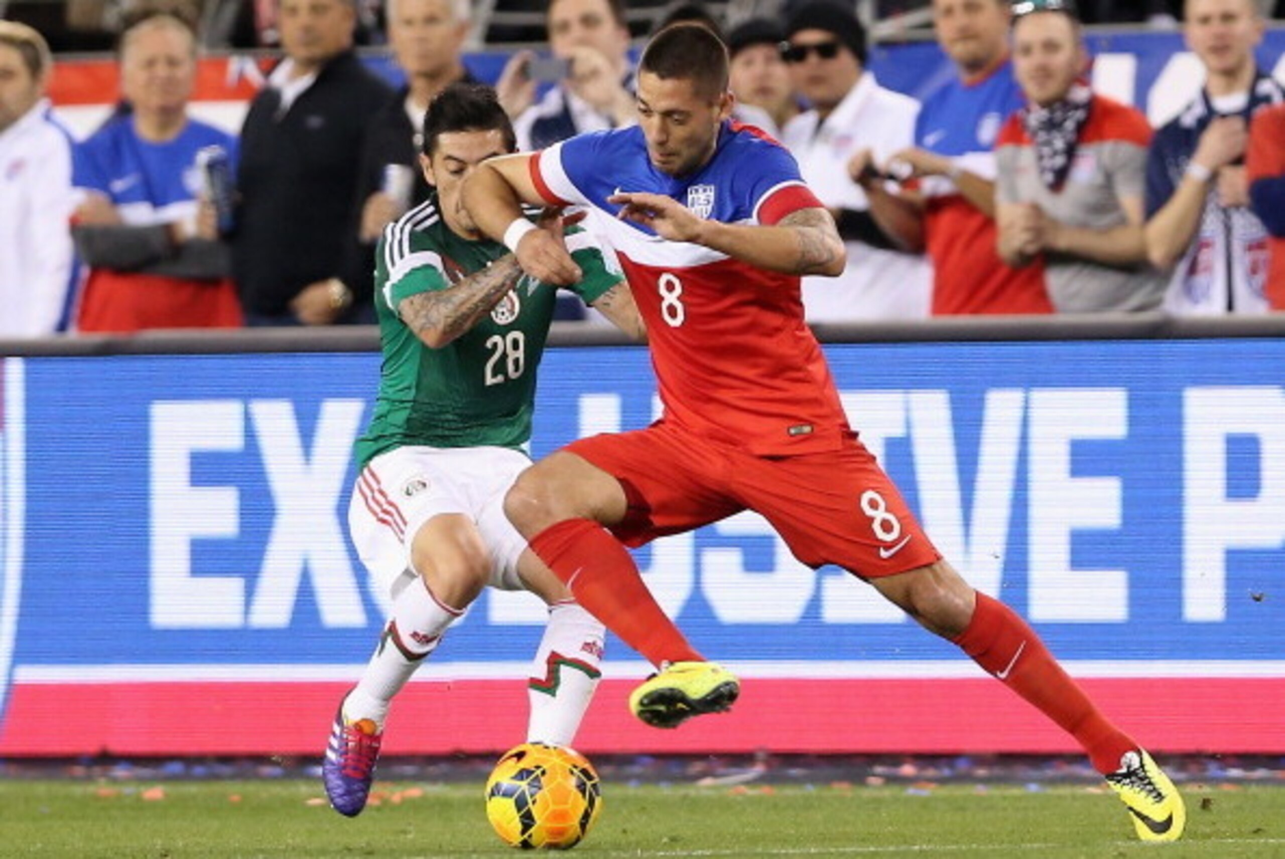 GLENDALE, AZ - APRIL 02:  Clint Dempsey #8 of USA controls the ball under pressure from Rogelio Alfredo Chavez #28 of Mexico during the first half of the International Friendly against Mexico at University of Phoenix Stadium on April 2, 2014 in Glendale, 