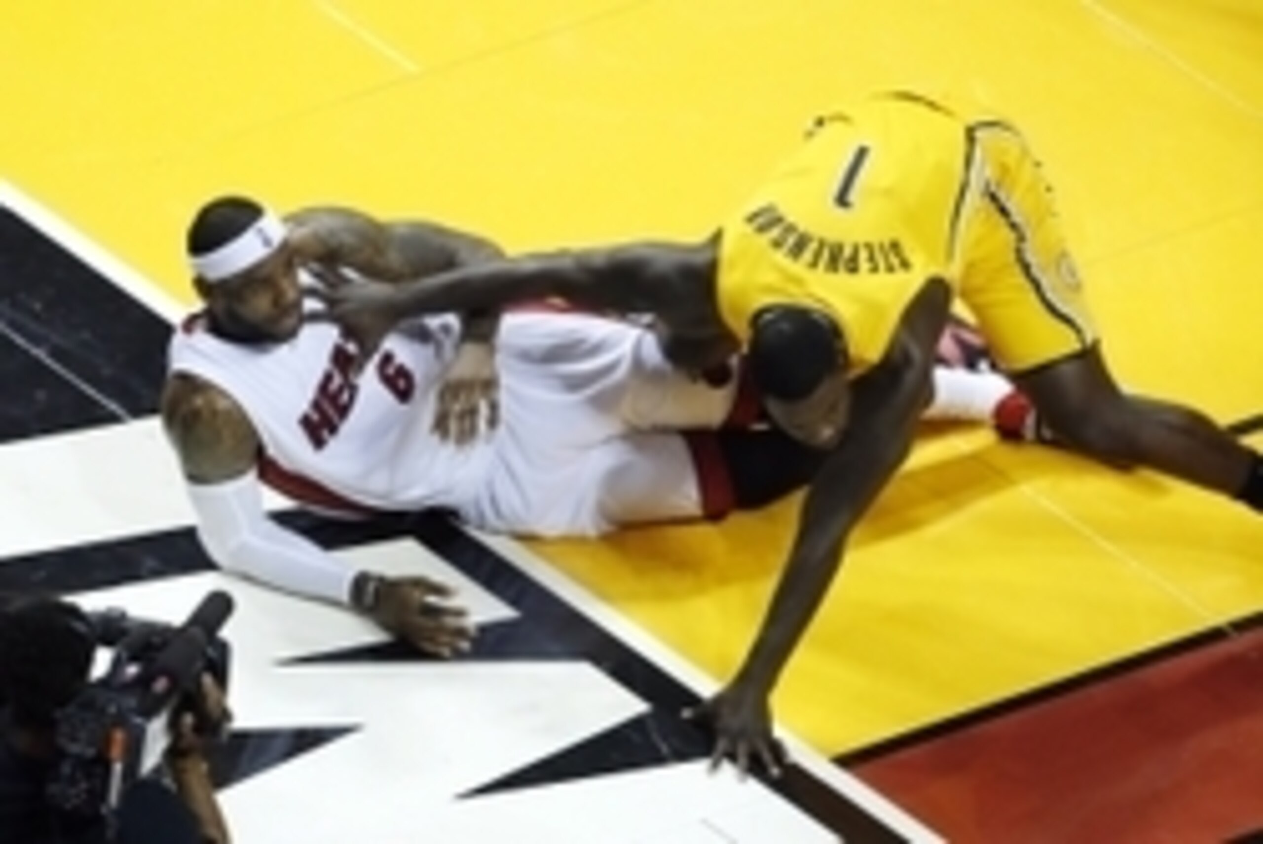 May 30, 2014; Miami, FL, USA; Indiana Pacers guard Lance Stephenson (1) trips over Miami Heat forward LeBron James (6) during the first half in game six of the Eastern Conference Finals of the 2014 NBA Playoffs at American Airlines Arena. Mandatory Credit