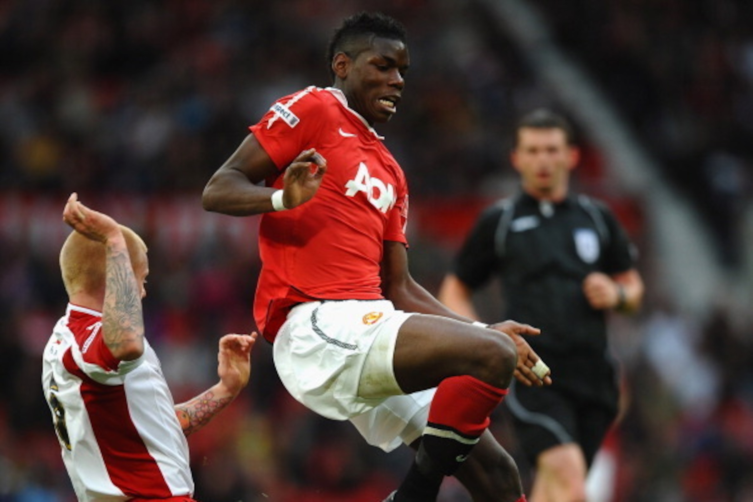 MANCHESTER, ENGLAND - MAY 23:  Paul Pogba of Manchester United is tackled by Terry Kennedy of Sheffield United during the FA Youth Cup Final 2nd Leg match between Manchester United and Sheffield United at Old Trafford on May 23, 2011 in Manchester, Englan