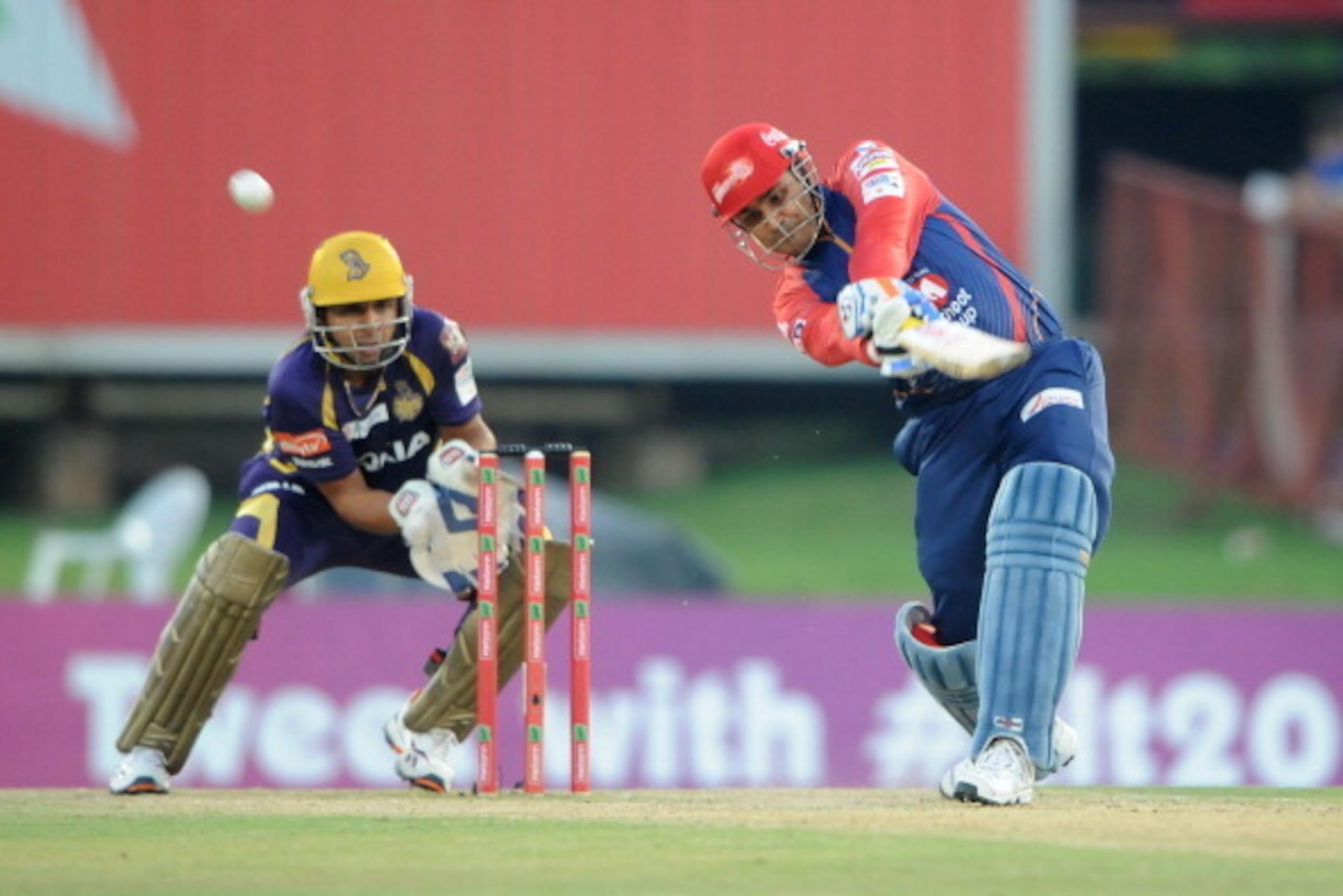 PRETORIA, SOUTH AFRCA - OCTOBER 13:  Virender Sehwag (R) of the Daredevils bats as wicketkeeper Manvinder Bisla looks on during the Karbonn Smart CLT20 Group A match between Kolkata Knight Riders (IPL) and Delhi Daredevils (IPL) at SuperSport Park on Octo