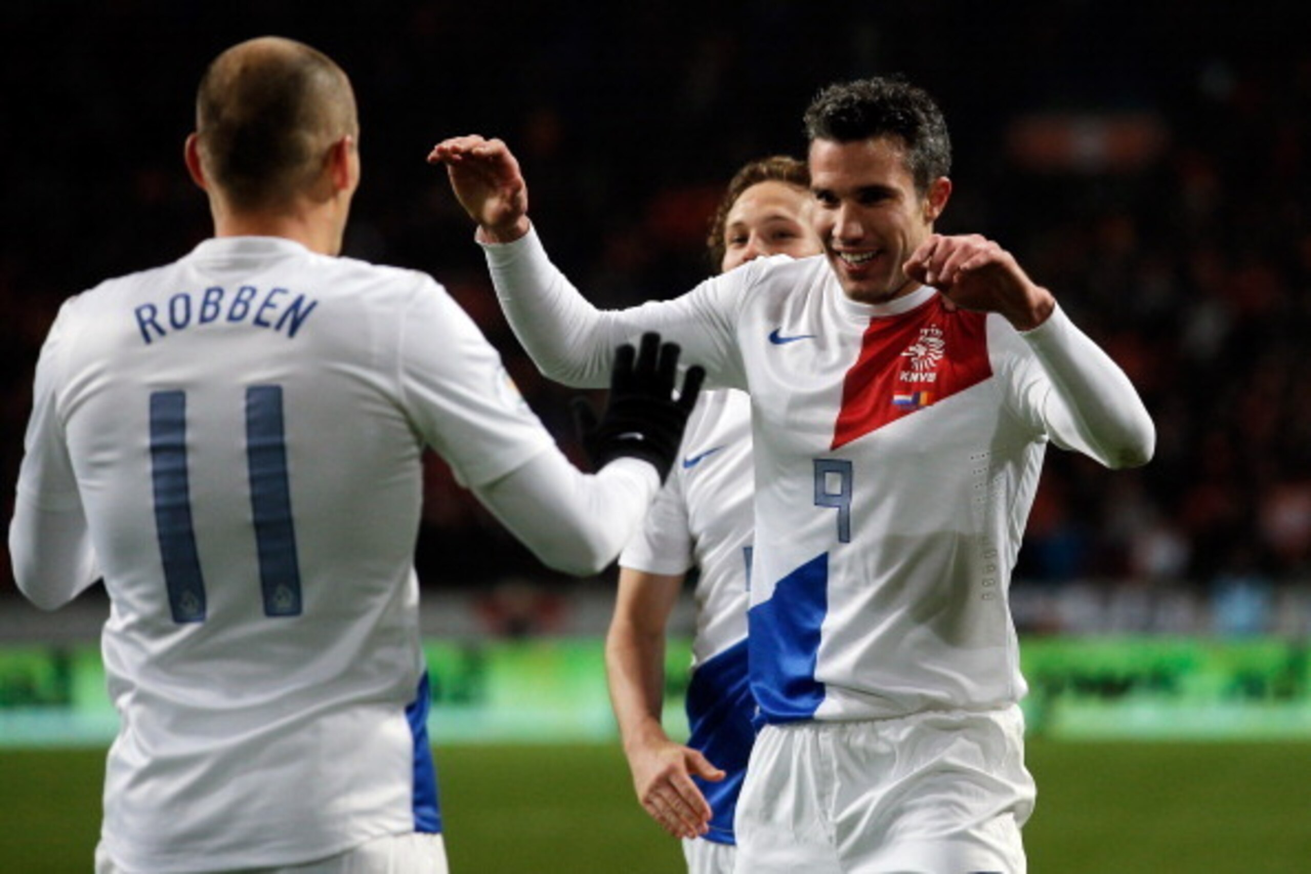 AMSTERDAM, NETHERLANDS - MARCH 26:  Robin Van Persie (#9) of Netherlands celebrates with team mate Arjen Robben after scoring the second goal of the game during the the Group 4 FIFA 2014 World Cup Qualifier match between Netherlands and Romania at Amsterd