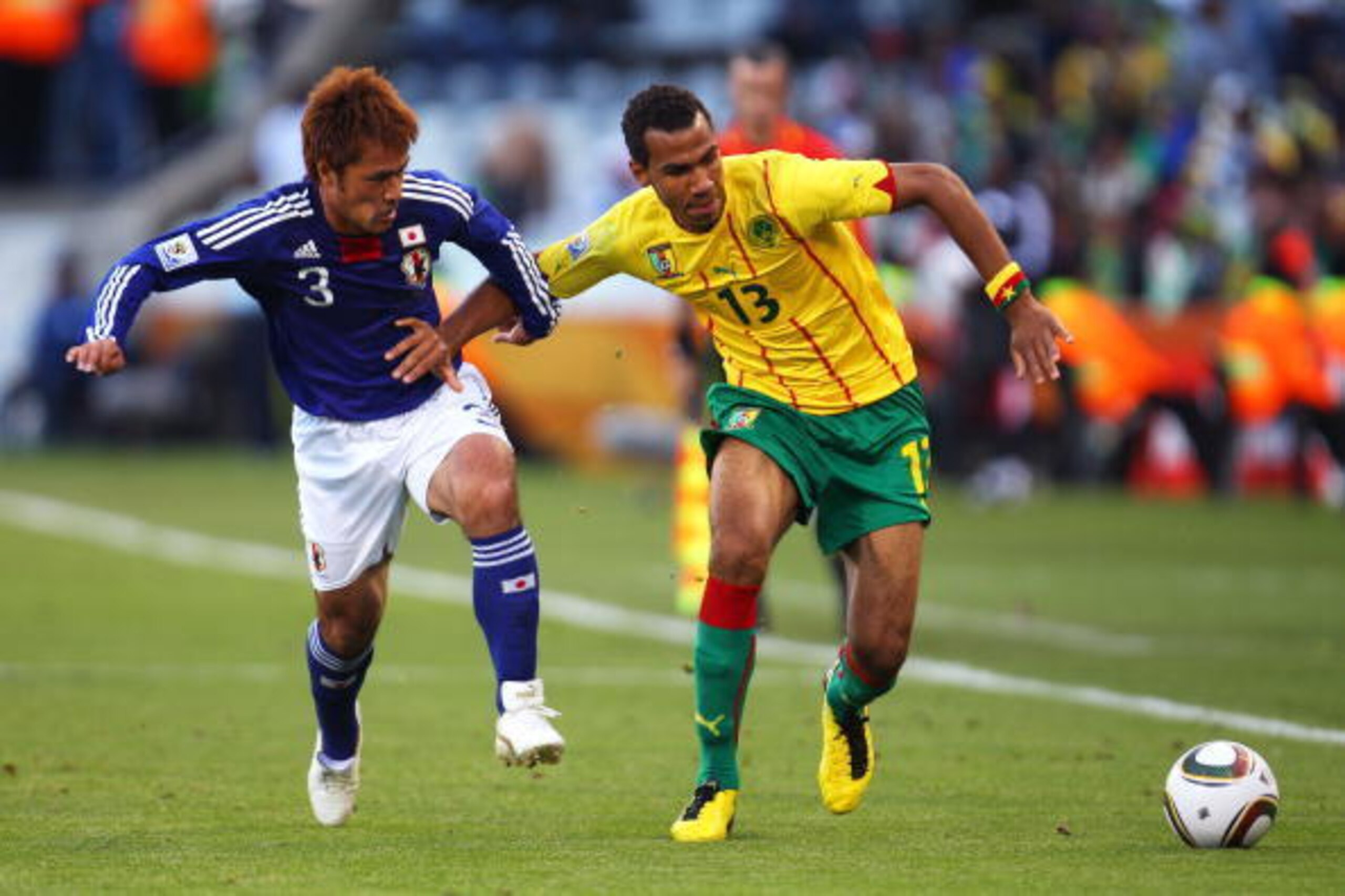 BLOEMFONTEIN, SOUTH AFRICA - JUNE 14: Yuichi Komano of Japan and Eric Choupo Moting of Cameroon battle for the ball during the 2010 FIFA World Cup South Africa Group E match between Japan and Cameroon at the Free State Stadium on June 14, 2010 in Mangaun BLOEMFONTEIN, SOUTH AFRICA - JUNE 14: Yuichi Komano of Japan and Eric Choupo Moting of Cameroon battle for the ball during the 2010 FIFA World Cup South Africa Group E match between Japan and Cameroon at the Free State Stadium on June 14, 2010 in Mangaun