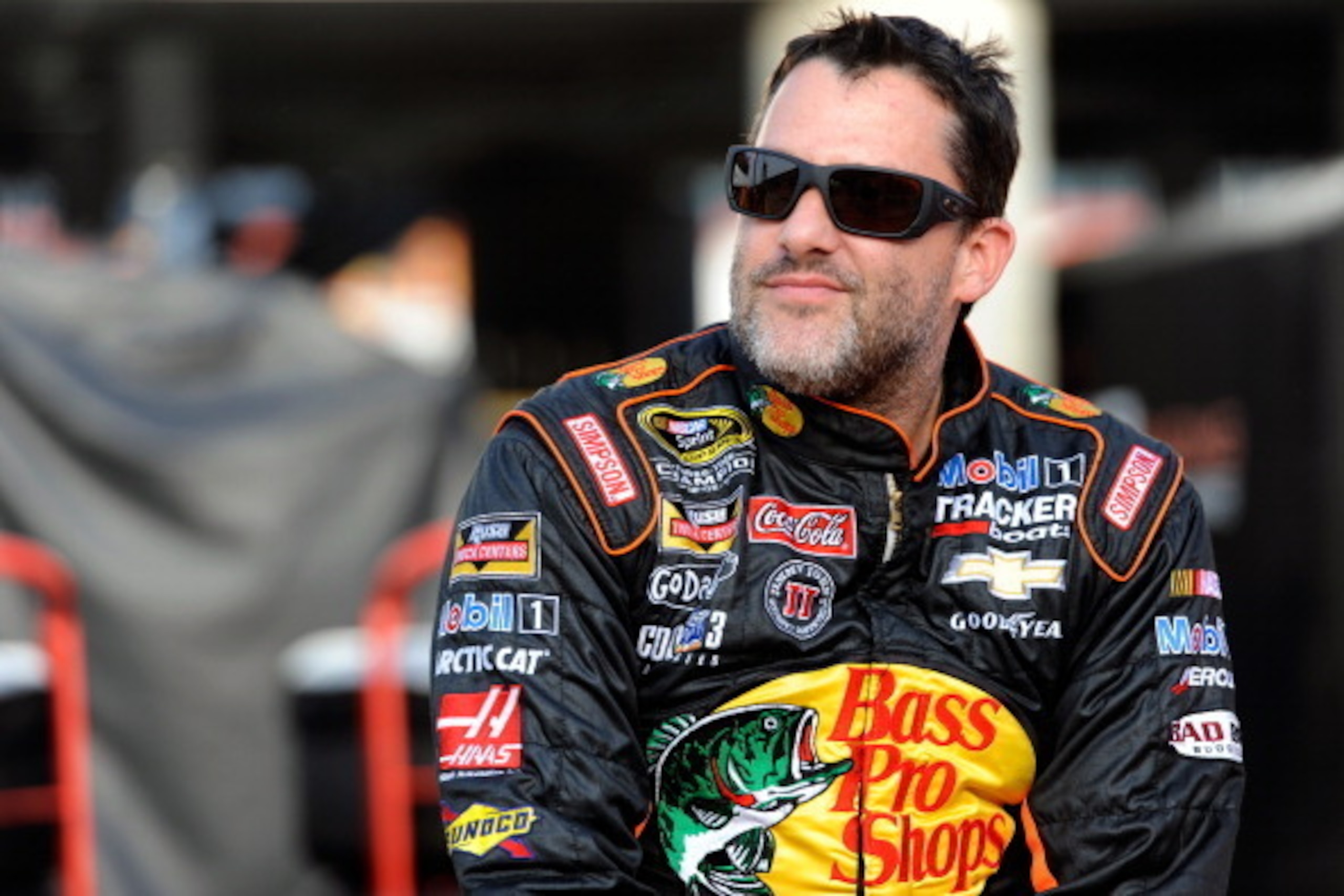 CHARLOTTE, NC - MAY 22: Tony Stewart, driver of the #14 Bass Pro Shops/Mobil 1 Chevrolet, sits on the pit wall during qualifying for the NASCAR Sprint Cup Series Coca-Cola 600 at Charlotte Motor Speedway on May 22, 2014 in Charlotte, North Carolina.  (Pho