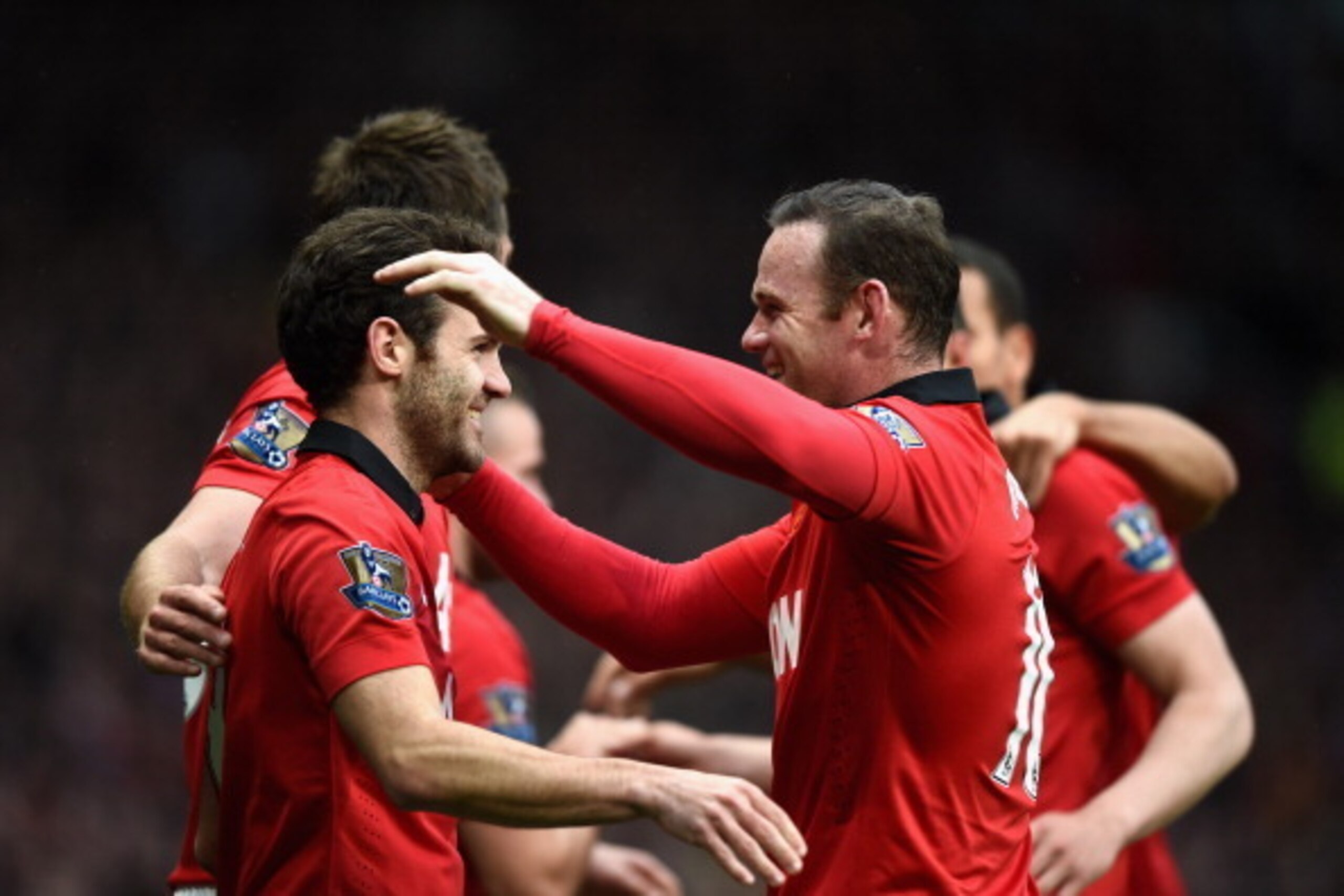 MANCHESTER, ENGLAND - APRIL 26: Juan Mata of Manchester United celebrates the fourth goal with Wayne Rooney during the Barclays Premier League match between Manchester United and Norwich City at Old Trafford on April 26, 2014 in Manchester, England.  (Pho