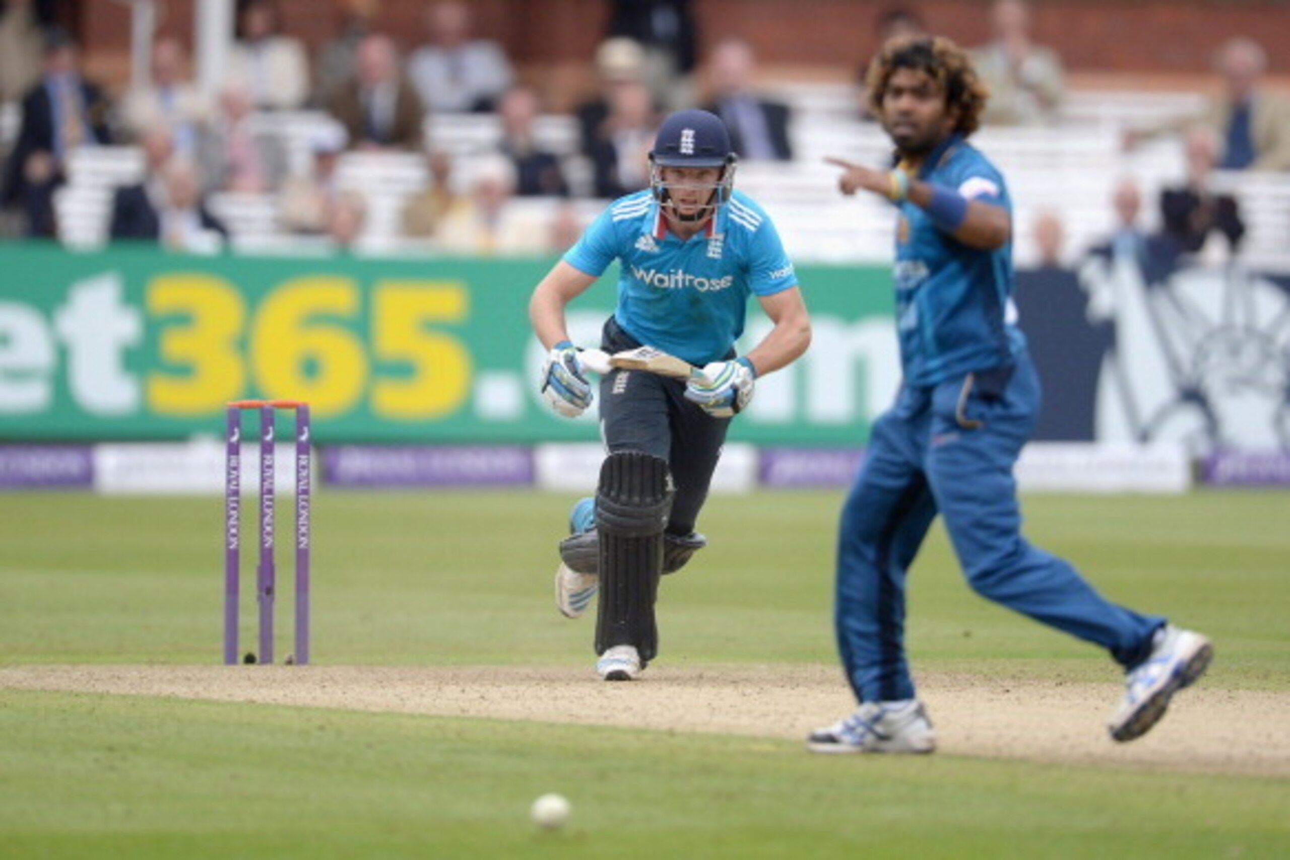 LONDON, ENGLAND - MAY 31:  Jos Buttler of England hits past Lasith Malinga of Sri Lanka during the 4th Royal London One Day International match between England and Sri Lanka at Lord's Cricket Ground on May 31, 2014 in London, England.  (Photo by Gareth Co
