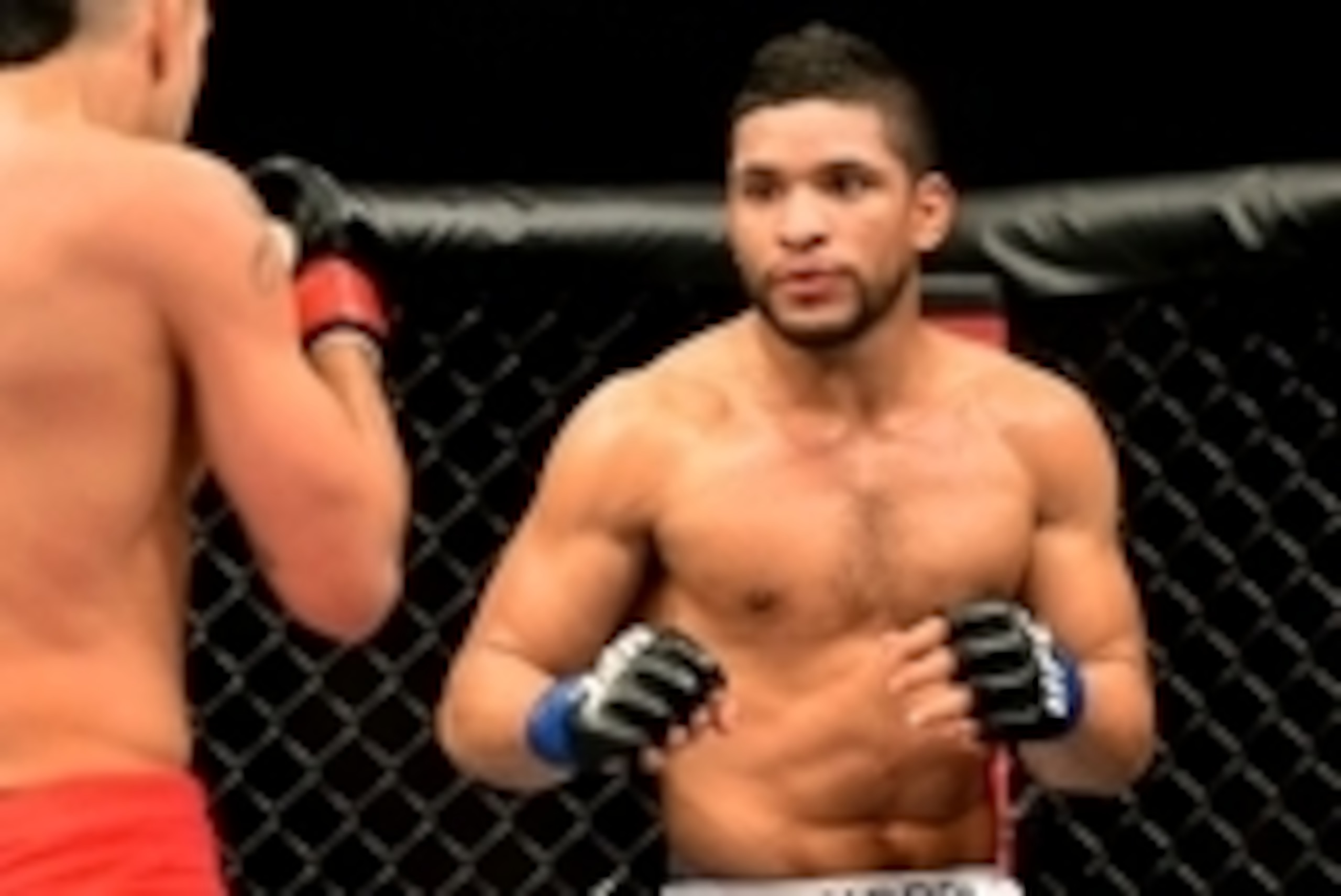 Feb 15, 2014; Jaragua do Sul, SC, Brazil; Felipe Arantes (red gloves) fights Maximo Blanco (blue gloves) during UFC Fight Night Machida vs Mousasi at Arena Jaragua. Mandatory Credit: Jason Silva-USA TODAY Sports