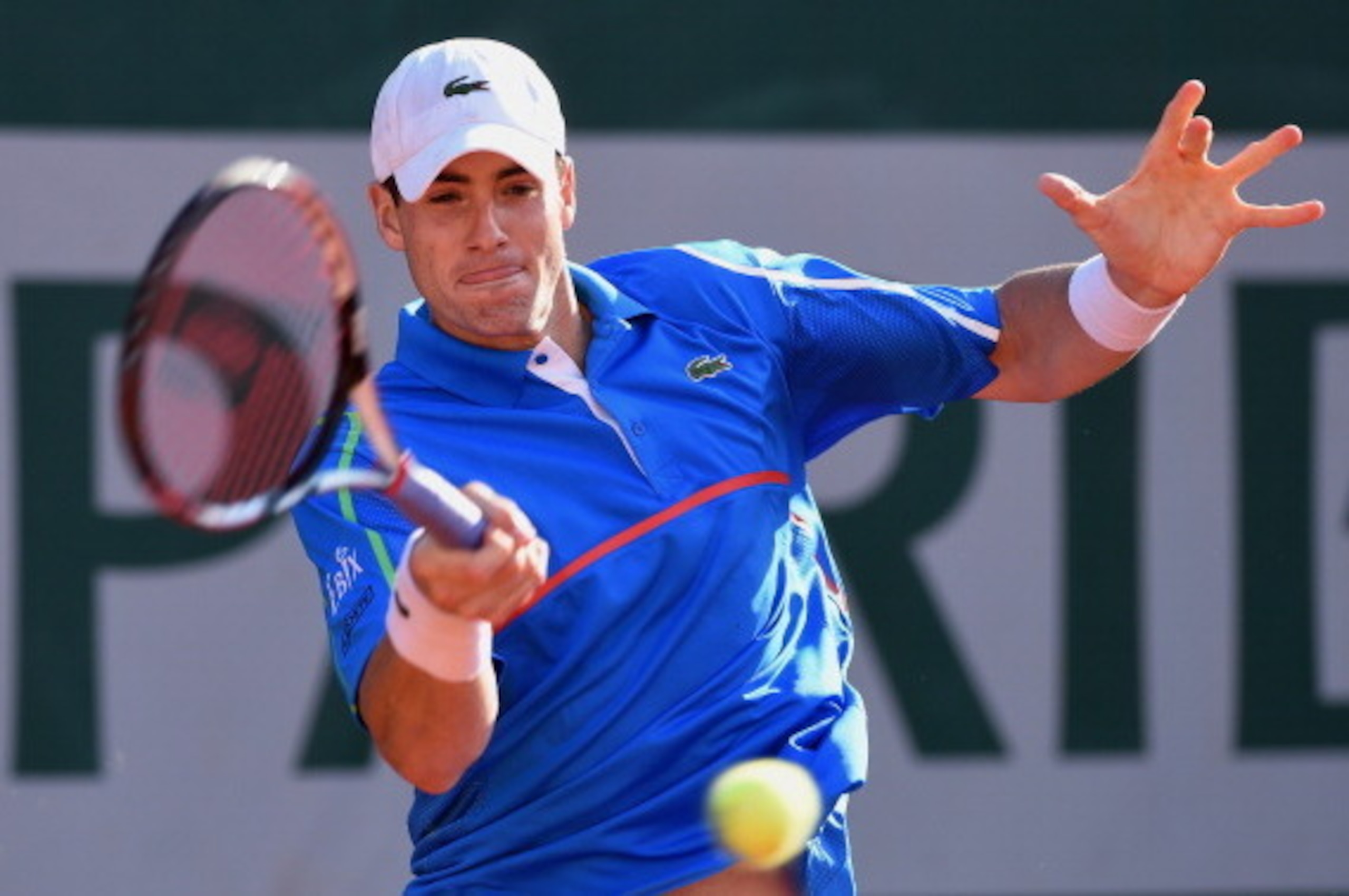 PARIS, FRANCE - MAY 30:  John Isner of the United States returns a shot during his men's singles match against Tommy Robredo of Spain on day six of the French Open at Roland Garros on May 30, 2014 in Paris, France.  (Photo by Matthias Hangst/Getty Images)
