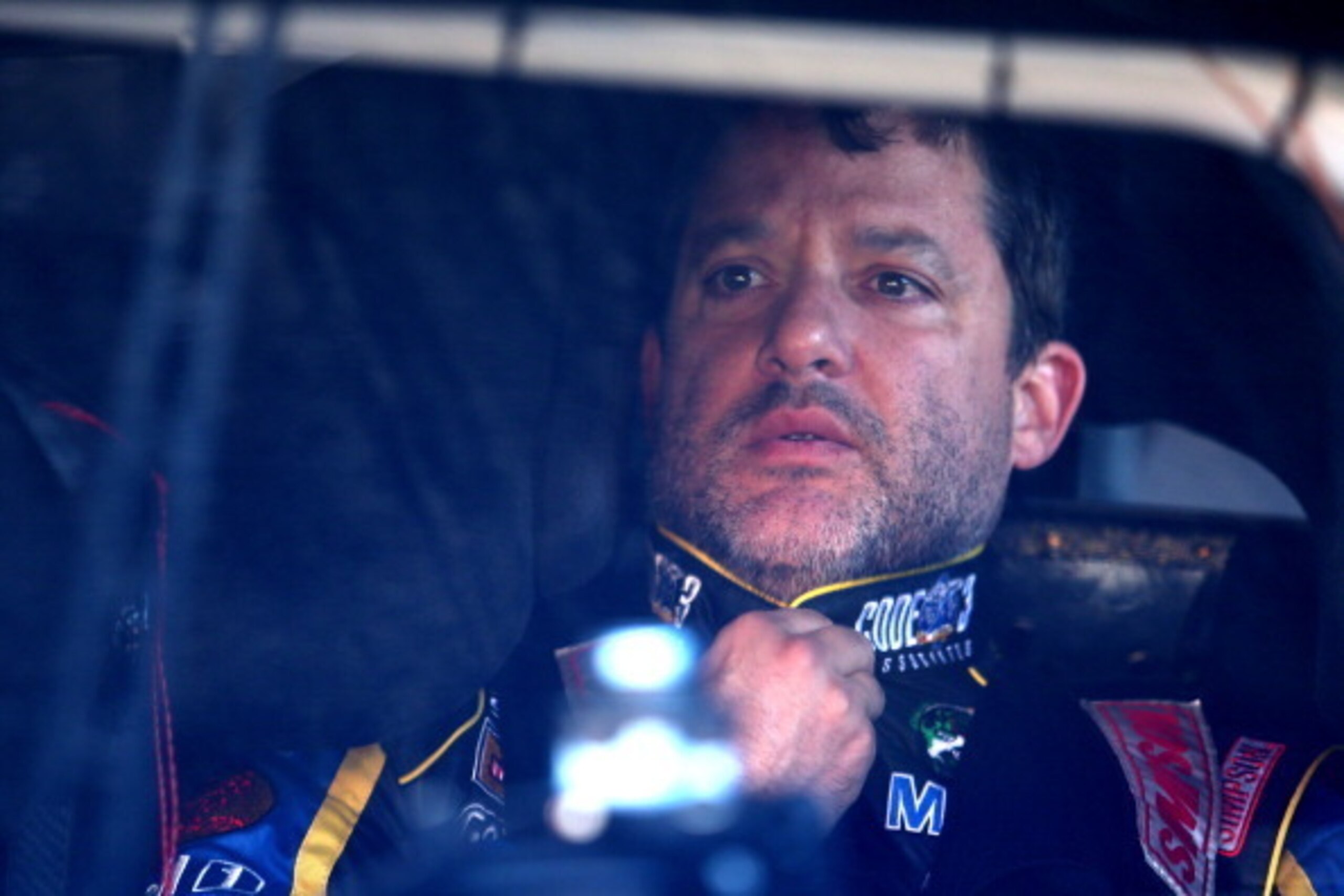 DOVER, DE - MAY 31:  Tony Stewart, driver of the #14 Code 3/Mobil 1 Chevrolet, sits in his car in the garage area during practice for the NASCAR Sprint Cup Series FedEx 400 Benefiting Autism Speaks at Dover International Speedway on May 31, 2014 in Dover,
