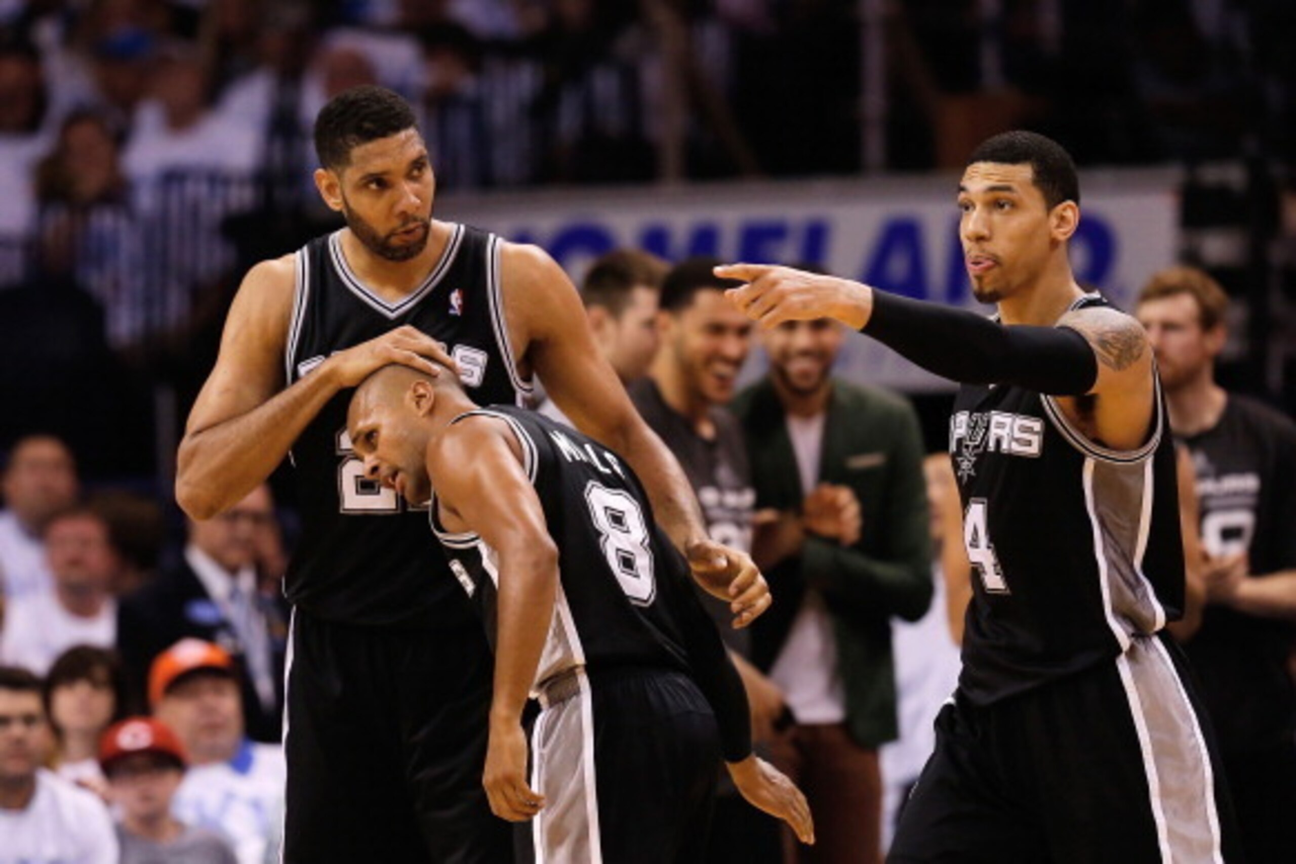 OKLAHOMA CITY, OK - MAY 31:  Tim Duncan #21, Patty Mills #8 and Danny Green #4 of the San Antonio Spurs celebrate a play against the Oklahoma City Thunder in the second half during Game Six of the Western Conference Finals of the 2014 NBA Playoffs at Ches