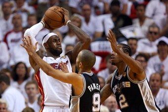 MIAMI, FL - JUNE 20:  LeBron James #6 of the Miami Heat looks to pass against Tony Parker #9 and Kawhi Leonard #2 of the San Antonio Spurs in the third quarter during Game Seven of the 2013 NBA Finals at AmericanAirlines Arena on June 20, 2013 in Miami, F
