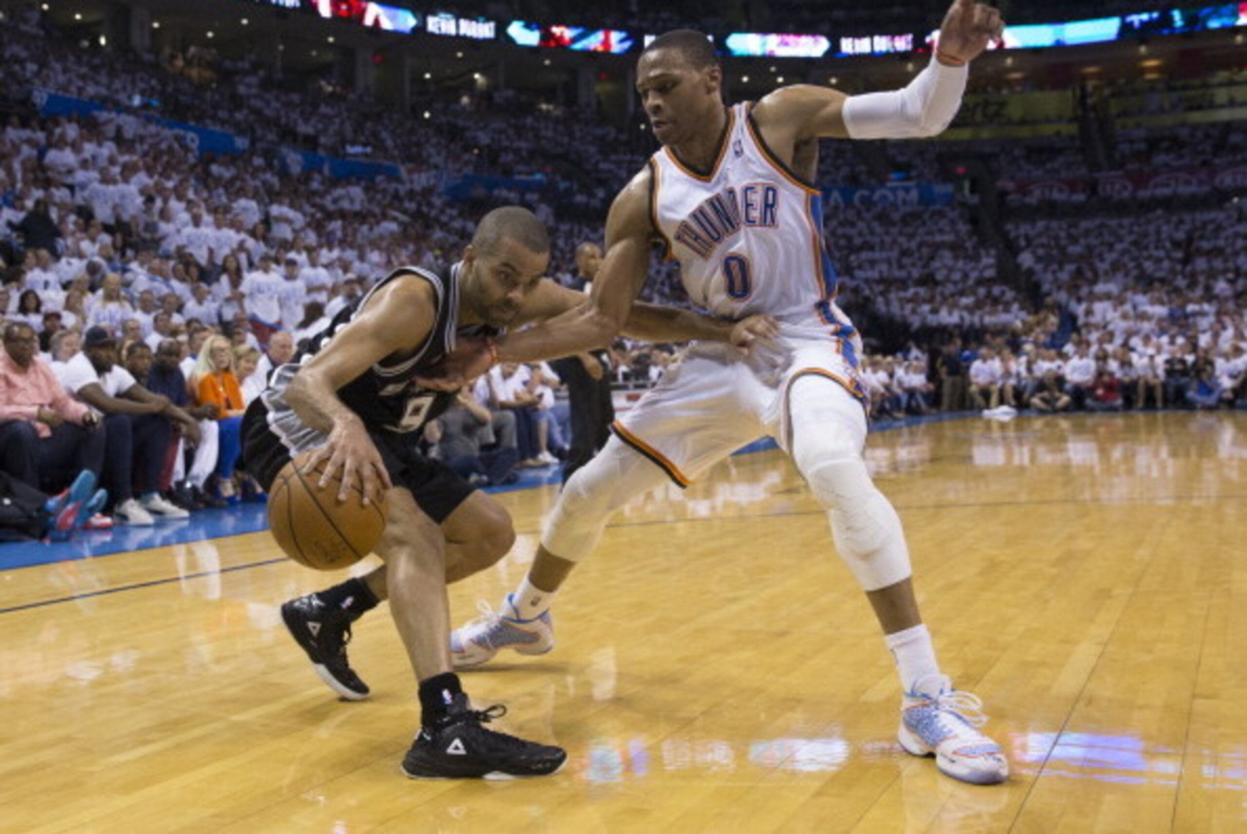 OKLAHOMA CITY, OK - May 31: Tony Parker #9 of the San Antonio Spurs drives against Russell Westbrook #0 of the Oklahoma City Thunder in Game 6 of the Western Conference Finals during the 2014 NBA Playoffs at the Chesapeake Energy Arena on May 31, 2014 in 