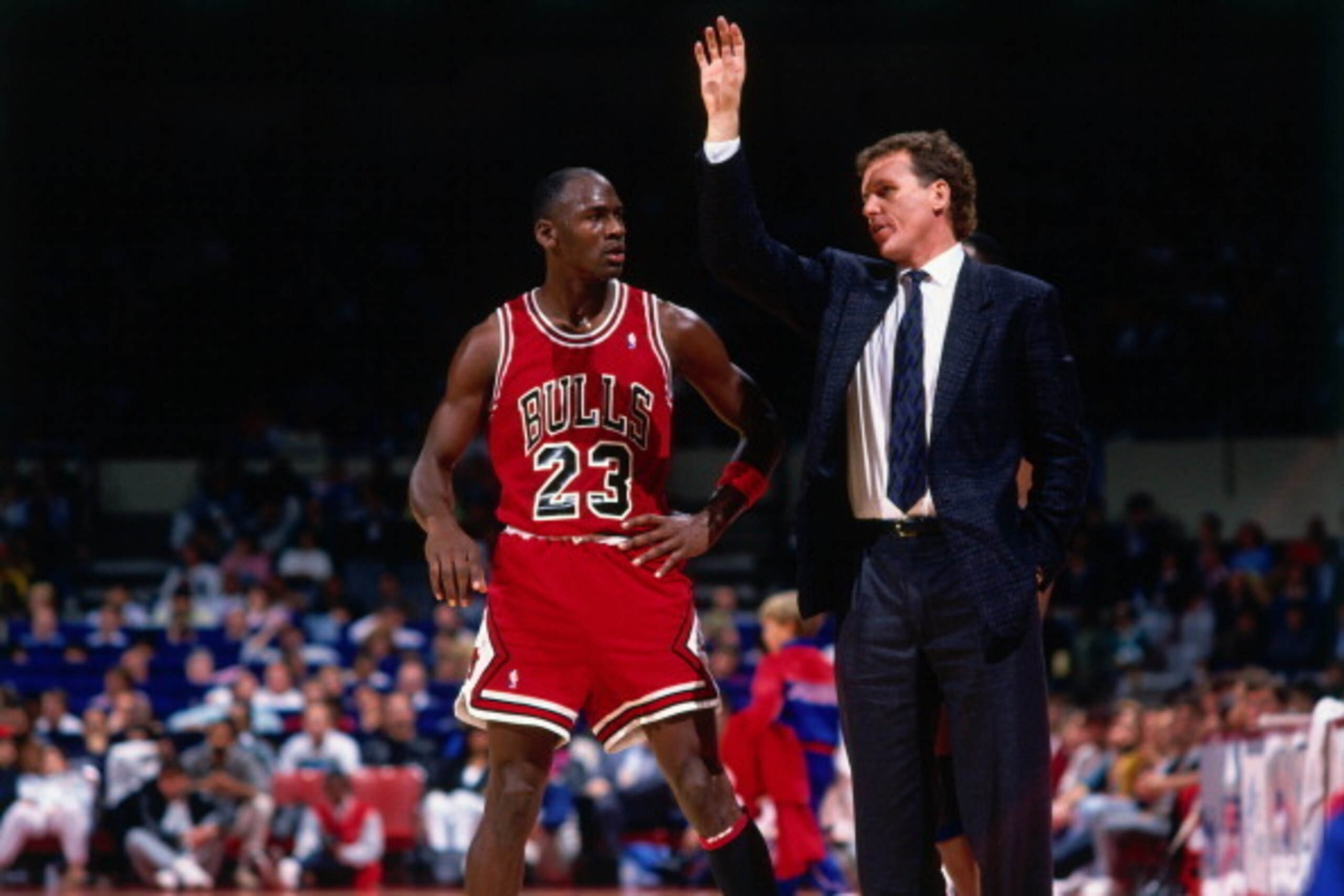 LOS ANGELES - CIRCA 1987: Chicago Bulls head coach Doug Collins talks with Michael Jordan #23 against the Los Angeles Clippers during a game played circa 1987 at the LA Sports Arena in Los Angeles, California. NOTE TO USER: User expressly acknowledges and