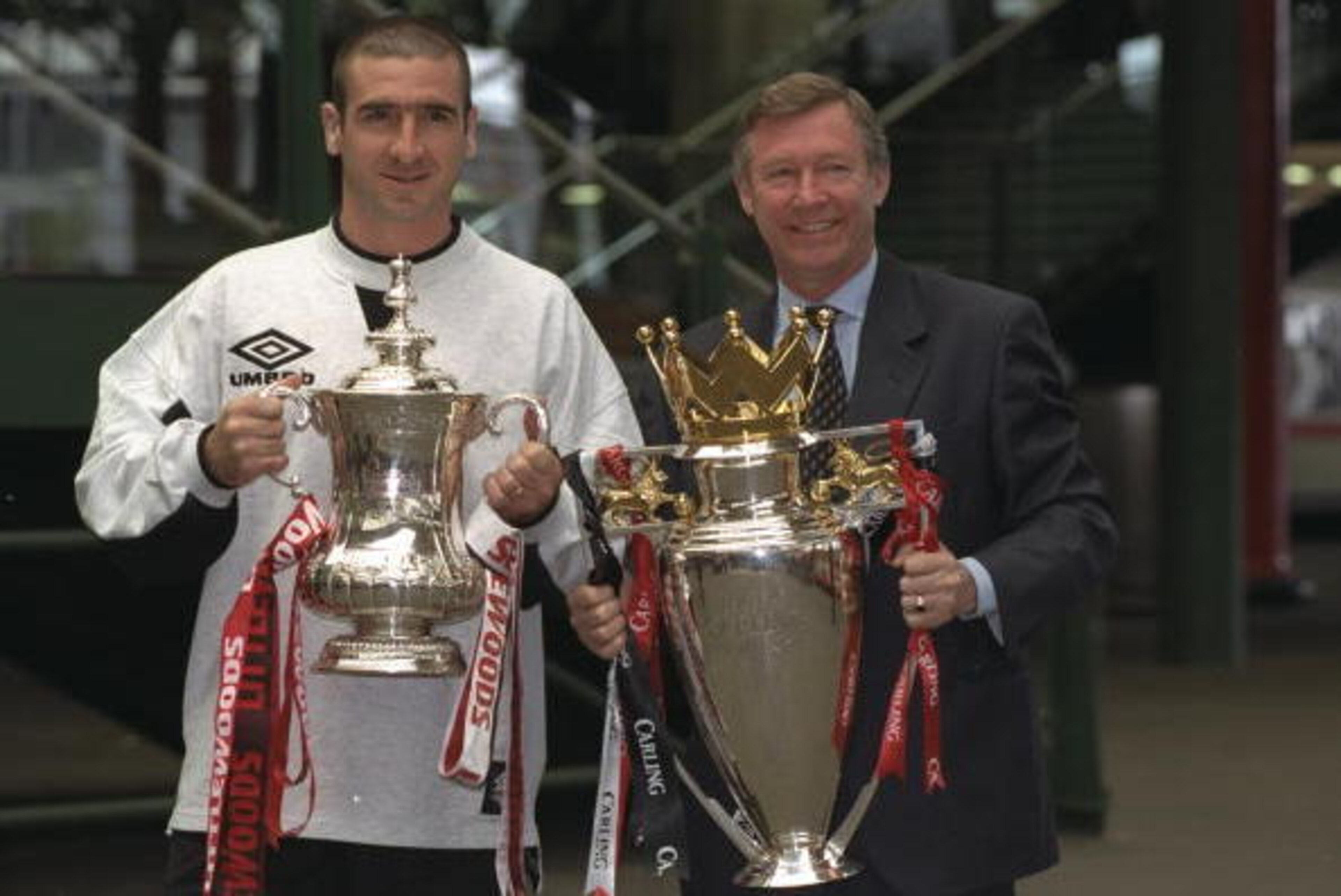 12 May 1996:  Eric Cantona (left) of Manchester United and Alex Ferguson (right) Manager of Manchester United hold the trophies after winning the F A Cup and the Premier League after the F A Cup Final match against Liverpool at Wembley Stadium in London.M