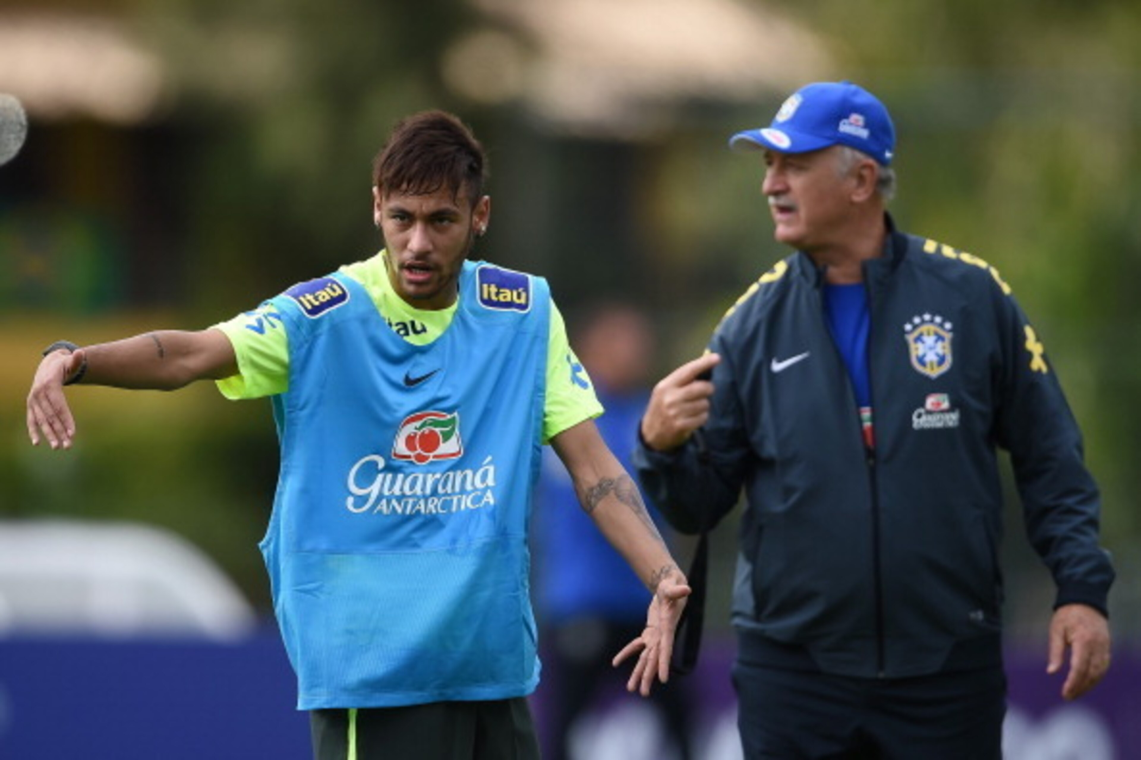 TERESOPOLIS, BRAZIL - MAY 29: Neymar gives instructions with a head coach Luiz Felipe Scolari during a training session of the Brazilian national football team at the squad's Granja Comary training complex, in Teresopolis, 90 km from downtown Rio de Janei