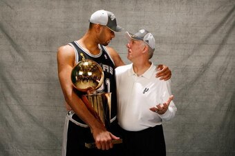 CLEVELAND - JUNE 14:  (L-R) Tim Duncan #21 and head Gregg Popovich of the San Antonio Spurs pose for a photo with the Larry O'Brien Championship trophy after they won the 2007 NBA Championship with their 83-82 win against the Cleveland Cavaliers in Game F