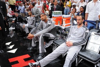 MIAMI, FL - JUNE 20: Tony Parker #9, Tim Duncan #21 and Manu Ginobili #20 of the San Antonio Spurs sit on the bench prior to the start of Game Seven of the 2013 NBA Finals against the Miami Heat on June 20, 2013 at the American Airlines Arena in Miami, Fl
